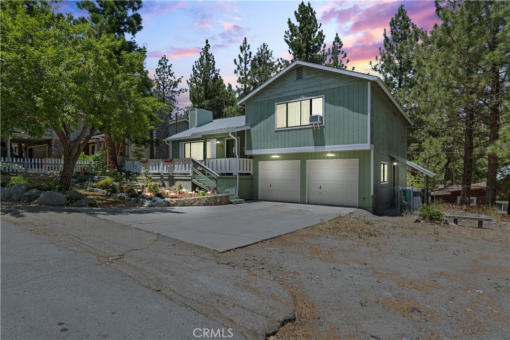 Tucked away nicely on a cul-de-sac location, this bird street home which offers 3 bedrooms, 2 bathrooms and a 2 car garage is sure to please!! This well loved home has had some upgrades as well, including a new roof, new septic tank and all new plumbing throughout! This South facing home gets plenty of natural light year round, with spectacular views of the Eastern San Gabriel Mountains to boot. Inside, you're warmly greeted by a large living room with wood burning fireplace, productive window A/C unit and lots of windows to bring the sunshine in. The front entry also has plenty of closet space for the boots, hats and coats on those wet, snowy days! Opening up to the country kitchen and dining area, you'll find lots of cupboard and counter space for the appointed Chef, built in microwave, recessed lighting and easy maintenance tile floors. The dining area has a slider to the rear deck for great BBQ possibilities and easy entertaining options! This tri-level home breaks up the stairs nicely, with two large, well appointed bedrooms including the primary with walk in closet and Jack and Jill en suite bathroom on the top level. The upgraded dual vanity is great for the busy family and the 9-5 grind. Tree top views from the bedroom windows, equipped with ceiling fans and ready for any size bed, remind you of your beautiful forest surroundings! Downstairs, another nice sized bedroom with forest views, 3/4 bathroom with newer shower and vanity and direct garage access make the Costco haul a breeze! Indoor laundry room is off the 2 car garage as well, along with access to the rear and side yards. Let's talk location....this charming home is just a few steps to gorgeous hiking trails and conveniently located a few blocks from the famous Wrightwood Country Club and a 10 minute walk to downtown Wrightwood, and just a block away from Lone Pine Cyn. Rd. for easy commuting options. Form meets function with this turn key home....its time to change your latitude and head up to the land of four seasons, fresh air and a true small town feel in picturesque Wrightwood!