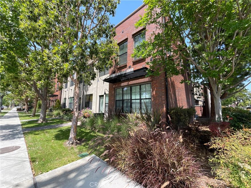 Built in 2007 Live/Work Condo Development in the Old Towne Orange Area. First LEED Certified homes in the City of Orange. On the exterior, you have a Brownstone-inspired look with exposed brick, industrial metal black accent, with large windows facing the street. This corner unit has one of the best views with a front street view of Maple Ave and the Sante Fe Depot Metro Station. Starting from the lower level you have a glass door entrance with a keypad lock. Off the entry, you are greeted with a large room downstairs that can either be used as an office or a bedroom with 2 large windows. Downstairs you have wood-like porcelain tile flooring throughout, an in-unit stacked washer/dryer, with a 1/4 bathroom. Upstairs you have quartz countertops in the kitchen and both bathrooms. Upstairs, the Great Room/Living Room is open to the kitchen with recessed LED lighting and pendant lights above the bar countertop. In the Great Room, you have an electronic starter gas fireplace with carpet throughout, you have 6 large windows overlooking Maple Ave and the Metro Station. The kitchen that is open to the Great Room has a stainless steel dishwasher with a 5 burner gas stove/oven and a brushed metal kitchen faucet with a garbage disposal. Down the hall, you have a separate 3/4 Bathroom. The guest bedroom features sliding closet doors with direct access to the sliding glass door to the private patio. The primary bedroom features 4 large windows with a connected Primary Bathroom with dual vanity sinks and a standalone tub with a separate standing shower. The Master Bathroom also has a connected walk-in closet with a large window facing the train tracks. The home also features dedicated solar panels on the roof that assist in lowering energy costs through NET meters. You also have central heating and air controlled by Nest Thermostat. Downstairs you have direct access to 2 car garage where the tankless water heater is located.