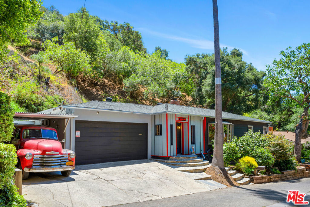 Tucked away on a tranquil street in the highly sought-after historical BHPO neighborhood, this charming 2-bed, 1-bath canyon house is on the market for the first time in over 30 years. Originally built in 1951, it is bursting with artistic charm, perfect for creative people.Step inside to discover original hardwood floors and vintage tile that celebrates the home's mid-century soul. A cozy wood-burning fireplacewith a gas jet optionanchors the living space, creating the perfect atmosphere for reading, dreaming, or unwinding. The house has also been updated with brand-new copper plumbing running from the street to the house. The backyard opens up to big sky views, a drought-resistant natural stone yard, beautiful potted plants, a sun deck, and a detached contemporary-designed studio perfect for an office or an art space. In the center, a concrete oval fountain attracts many native birds, transforming this backyard into an oasis. The two-car garage currently functions as an art studio but can easily return to its original use. Plus, a spacious two-car carport and additional front parking adds a rare practicality. With its unique style, this home presents an extraordinary opportunity for the discerning buyer. Ideally located just minutes from Beverly Hills, Westwood, Warner School, and the Valleyyet tucked away in serene privacyit's a truly incomparable find!