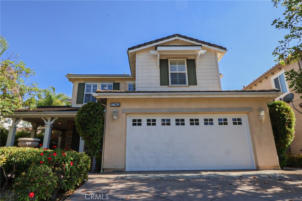 This meticulously designed 5-bedroom, 4-bathroom home offers an exceptional blend of luxury and function. Upon entry, you are greeted by 20-foot ceilings and polished travertine flooring that flows throughout the main level. The floor plan includes formal living and dining rooms, a dual-sided fireplace, and a desirable downstairs bedroom with a full bathroom. The gourmet kitchen is appointed with granite countertops, a massive center island, and a butler's pantry, opening to a spacious family room. A circular stairway leads to the second level, which hosts three full bathrooms and four additional bedrooms, including the expansive master suite. This private retreat features a large walk-in closet, a separate tub and shower with dual sinks, and a private balcony with a gorgeous view. The property is complete with a built-in backyard BBQ, a putting surface for recreation, and a 3-car tandem garage for ample parking and storage.
