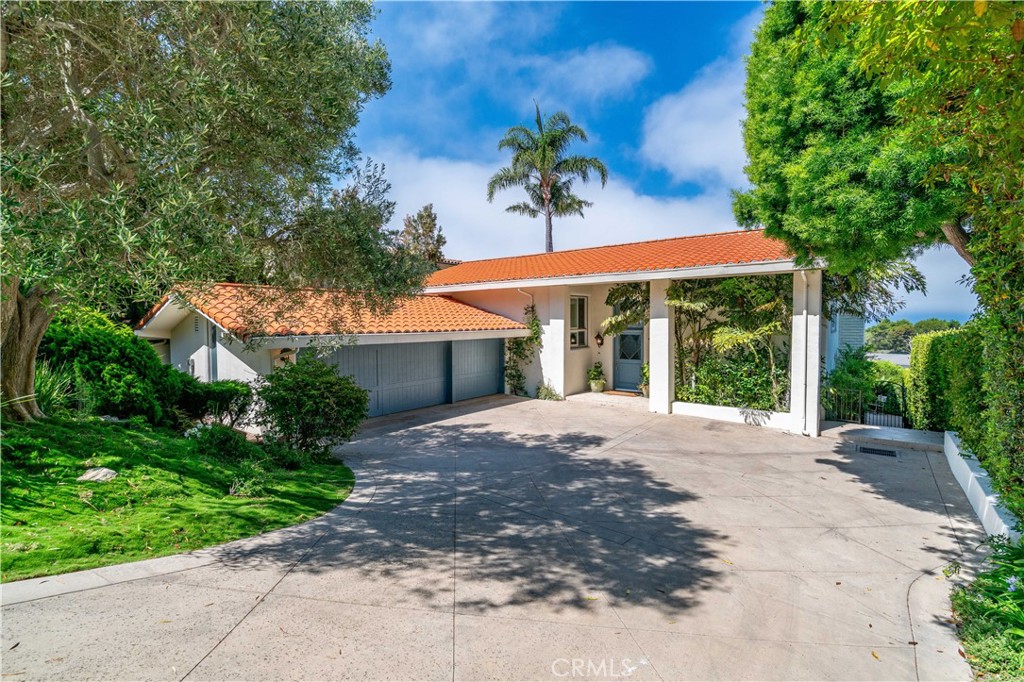 Experience the best in Palos Verdes luxury real estate with this beautifully updated ocean view home designed for comfort, style, and sophistication. Situated in Lunada Bay of Palos Verdes Estates, one of the most desirable neighborhoods, this residence offers expansive views, a thoughtful floor plan, and elegant upgrades throughout. The top floor boasts soaring high ceilings and oversized windows framing the breathtaking views. The gourmet custom kitchen features a center island, premium marble countertops, and fresh white cabinetry, seamlessly connecting to the formal dining room. The recent upgrades consist of high quality materials and fabriacation, built to last. Also on the top level are a well-appointed three-quarter bath, a guest bedroom, plus the luxurious primary suite—complete with a spa-like bathroom, walk-in closet, and direct access to a private balcony and ocean view deck. The lower level offers a spacious family room, a bedroom converted into a play area (easily reverted to a fifth bedroom), two good sized bedrooms, and a stylish full bath. All rooms are generously sized, providing flexible living options for family and guests. Step outside to a beautifully landscaped backyard with a built-in gas firepit, lush grass area, and mature fruit trees; orange, kumquat, plum, peach, lemon and lime. The sloped driveway leads to a private three-car garage, ensuring both privacy and convenience. 1232 Via Coronel is perfect for those seeking a luxury home in Palos Verdes with ocean views; this property combines coastal elegance, modern upgrades, and a prime location close to schools, shopping, and scenic trails.