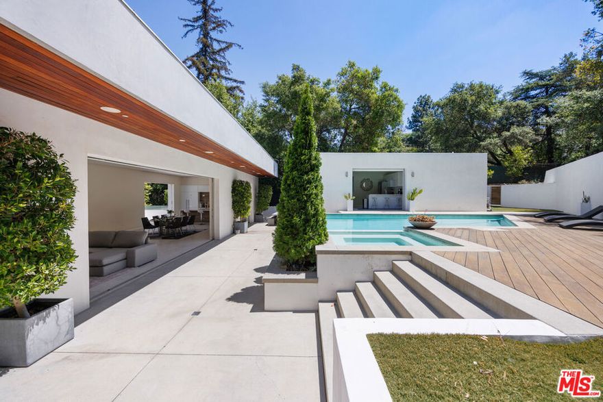 Sherman Oaks compound offering an effortlessly relaxed California lifestyle. Stunning glass walls welcome you into the two-story entry level with a family room, movie theatre, and lavish primary suite. A striking floating staircase leads to the main level, encompassing the living room, dining room, and a chef's kitchen with Thermador appliances and bespoke Italian cabinetry. Expansive Fleetwood pocket doors open to the resort style backyard with infinity pool and spa, multiple grassy areas, and a fantastic 1 bedroom guest house. With Control 4 smart home features, generous parking, captivating views and elevator, this home offers all of the style and amenities you're looking for.