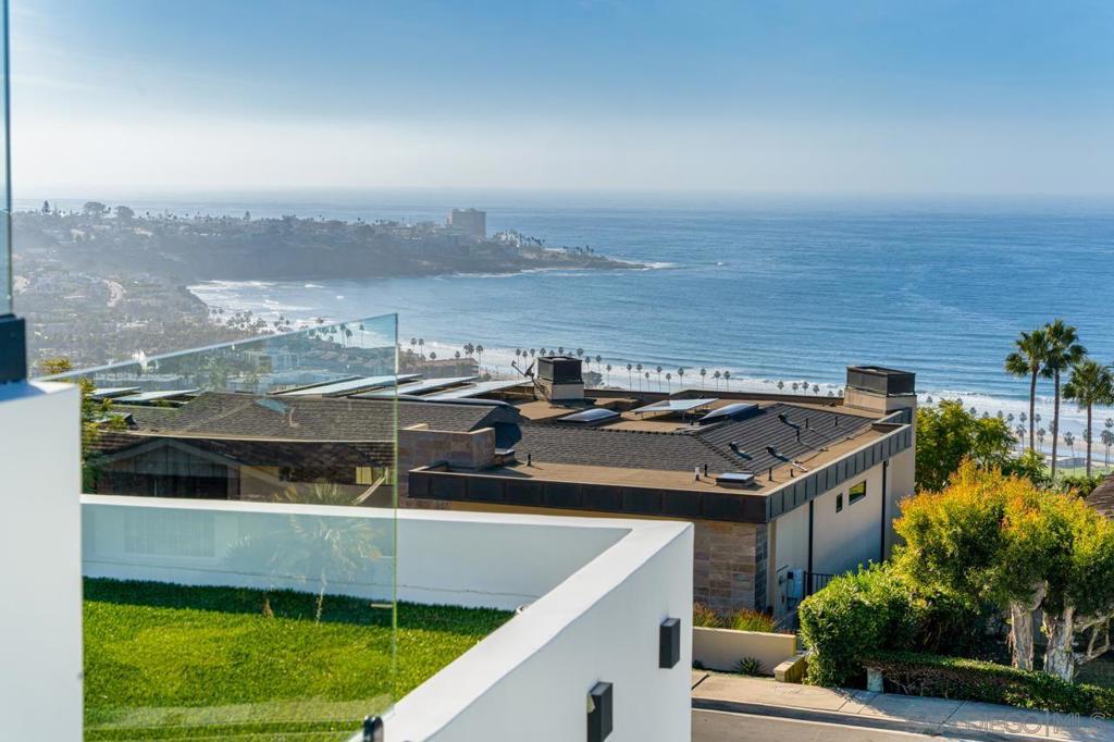 *** 15 Reasons why you will love this home *** 1) JAW DROPPING 240-degree Panoramic Views of the ocean and coastline. 2) 2023 Luxury New Build by Archbel Builders. 3) Stunning Modern Architecture. 4) High-end use Materials. 5) Large Lot with Sunny Pool & Spa. 6) Indoor Outdoor Living 7) Custom Windows and Doors 8) Custom and dramatic Kitchen with Ocean Views and Top Shelf European Appliances additional prep Kitchen 9) Impressive Bar with Wine Dispensers and Coffee Machine 10) Elevator Ready. 11) Spacious bedrooms all are ensuite. Spa-like Bathrooms. 12) All livable spaces have white oak flooring. 13) Multiple Ocean View Verandas and Roof Top Deck. 14) Smart Home – Audio and Video. 15) Oversized 3 car Garage *** Additional Remarks *** Perfectly situated overlooking La Jolla Shores Beach, " Oceano Haus" is an artful blend of elegance with notable, modern design & quality craftsmanship. This home hosts 5 bedrooms/5 bathrooms and two half bathrooms. Expertly designed & Built by Archbel Builders, featuring high quality materials. Precise attention to each & every detail has been used to create a sensational Modern home that seamlessly blends the best of indoor and outdoor living. Enjoy breathtaking Pacific and Coastal ocean views from many of the spaces in the home. Additional Features include: Large lot with Pool and Spa, Modern Open Floorplan, Fully Featured Bar, True Chef’s Kitchen with Italian ILiv Gas Cooktop and Vent hood & top shelf appliances. Spa Like Bathrooms, White Oak Flooring and Elegant Tile, Multiple Skylights, Ocean View & Large Roof Top Deck.