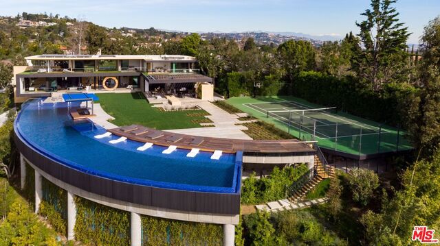 Set on a sprawling acre-plus promontory in Bel Air, the world's most prestigious neighborhood, you will find serenity redefined. Tucked behind gates is a cutting-edge organic modern paradise designed by Tag Front Architects w/the world's finest appointments: oversized gardens, professional tennis court, 12-car garage, & a pool the size of The Pacific Ocean. Experience the pinnacle of sophistication & modern design w/museum quality finishes throughout & unparalleled views from the Getty to Catalina. No expense was spared in draping every inch in the world's finest of everything; from the Italian kitchen to the Portuguese Limestone & Calcutta marble throughout. Offering the finest in indoor-outdoor living, find the purest form of living in a masterfully designed open floor plan w/a luxurious master suite, six guest suites, a twenty-person movie theatre, wine room, gym and spa. The world has never seen anything of this caliber before, why settle for anything less than the absolute best?