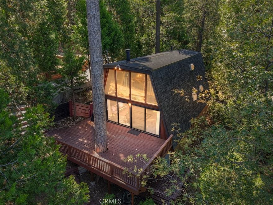 Charming Gambrel style cabin close to Lake Gregory.  This house is surrounded by towering trees and even comes with a view of the lake.  3 beds and 3 baths, loft, bright kitchen open to living area with wall of windows and sliders out to a huge deck perfect for entertaining.  Lower level has separate entrance with ADU or multi generational living potential.  2024 upgrades include new roof, new plumbing throughout, new water heater and new forced air heating unit.  Ideally located in desirable San Moritz neighborhood close to shopping, recreation and commuter friendly.