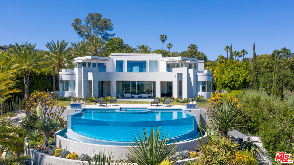 Located on very prime lower Tower Road, just 2 minutes behind the Beverly Hills Hotel. Beautifully situated at the top of a long gated private driveway, this spectacular modern masterpiece was designed by Richard Landry with no expense spared. The absolute highest level of quality, with explosive city views and rare amenities on nearly a one-acre lot. Entirely newly rebuilt contemporary estate, perfect California living, sliding walls of glass open to indoor/outdoor entertaining with expansive yard, patio/grass space, outdoor dining, firepit, walking paths and incredible infinity pool overlooking city to ocean views. The entire top level features an incredible master suite with dual baths, walk-in closets and a sprawling balcony. Very dramatic 30 ft entry features a Zaha Hadid designed floating wall. Large living room, dining room and gourmet kitchen, gorgeous bar, wine cellar, professional theater, office, and spa/massage/sauna facilities. An incredible value and rare opportunity!