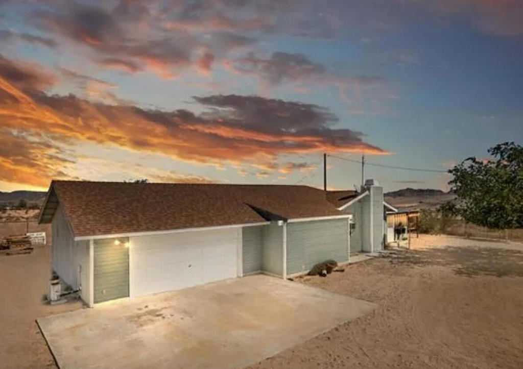 A 5-ACRE parcel in Landers to build your pool and spa getaway! Located by Goat Mountain, and moments away from Johnson Valley's King of the Hammers, you will find this parcel with gorgeous 360 degree panoramic views of all the surrounding desert. The parcel is bordered by Bureau of Land Management parcels so there will not be any building around you, indefinitely. This 3 bedroom, 2 bathroom 1768 sq ft home has the right amount of space. Bring your TLC and vision to make this a great primary, getaway or short-term rental. The kitchen has a wrap around counter with a breakfast bar set up . The living room has a wood burning brick fireplace and mantle, plus a wet bar. There is a nice size family room connected to the finished garage. Each room has a wall unit mini-split for cooling & heating including the garage, which makes for efficient energy use. The primary suite bathroom has been updated with 2 vanities and step in shower stall. Laundry area is located by main bedroom. There is a shed located outside in the back of the home. Approximately 1+ acre of this parcel is fenced. Bring your toys, park the RV's, or your trucking business; the options are endless. Enjoy the open space and all the desert has to offer such as: The Integratron, Landers Brewery, La Copine restaurant, Joshua Tree National Park, Pappy & Harriets, and more. Just a short drive to Palm Springs, JTNP, Big Bear Mtns., the Colorado River, Laughlin, Las Vegas, Los Angeles and more! Please call and make an appointment.