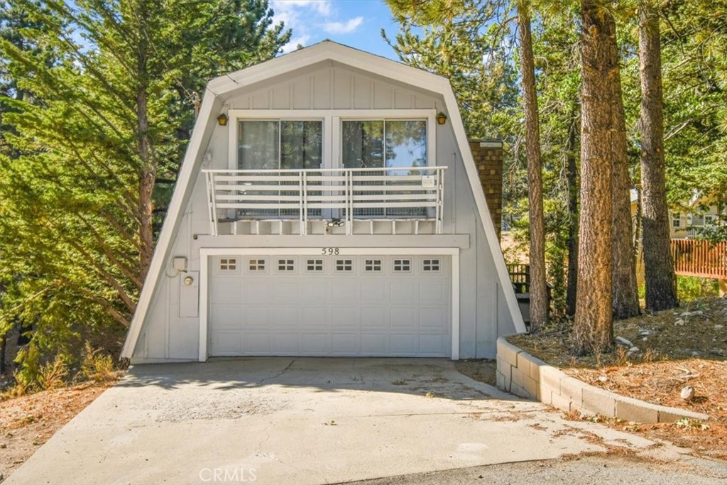A rare opportunity—this is one of the only homes at this price point in Green Valley Lake with an attached two-car garage and private driveway. Embrace the tranquility of your charming mountain retreat, nestled in the heart of the peaceful and picturesque Green Valley Lake. This cozy 2 bedroom, 2 bathroom home boasts 1275 sq ft of living space perfect for a weekend getaway or full-time residence. The open concept floor plan is filled with natural light and features a spacious kitchen, a wood burning stove, and stunning views of the surrounding forest. Outside, you'll find multiple decks perfect for enjoying the fresh mountain air and entertaining guests. Located just minutes from hiking trails, fishing spots, and the picturesque lake, this home offers the ultimate escape from city life. Don't miss your chance to own this hidden gem in Green Valley Lake! Property currently has a short term lodging permit. And the Bonus, a basement that can be transformed into additional living space and or a massive primary bedroom.