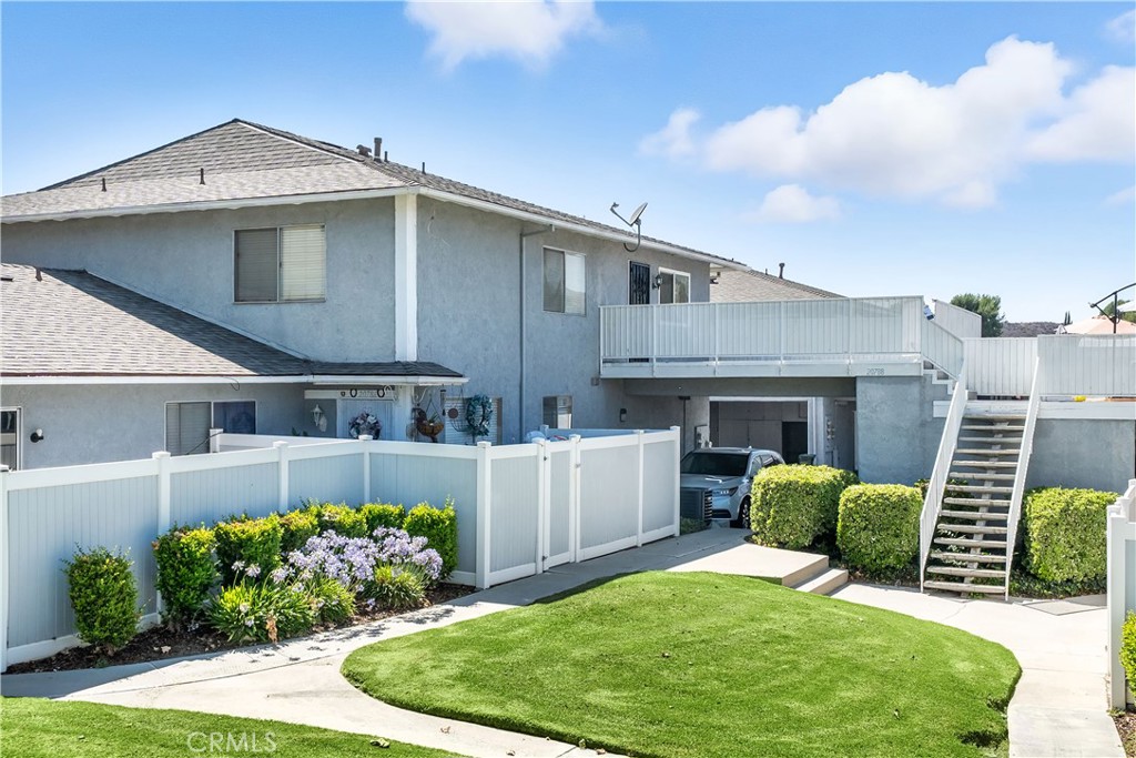 Welcome to this charming 2-bedroom, 1-bathroom upper-level condo in the desirable Bouquet Village community! This beautifully updated home features a freshly painted interior and brand-new water proof wood-style vinyl flooring throughout. Enjoy modern touches like newer doors and hardware, stylish lighting, and ceiling fans. The bathroom has been refreshed with a new vanity, fixtures, and mirror, while several windows—including the front-facing ones and one bedroom—have been replaced for improved comfort and efficiency. Plus, the AC unit is less than 2 years old! Situated in a prime location within the community with no rear neighbors, this unit offers a spacious front deck—perfect for relaxing or entertaining with your favorite patio setup and BBQ. Two covered, assigned parking spaces are conveniently located below the home. The low HOA includes access to a sparkling pool, sports court, and greenbelt areas. All just minutes from local dining, shopping, and more!