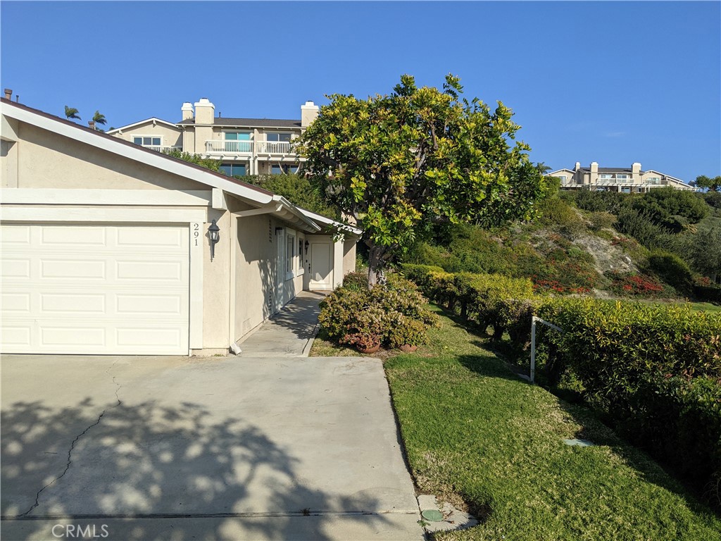 Here's a Peaceful & Private Single-Level Home with Expansive Views from Every Room over a Green Field to the Pacific Ocean. This lovely End-Unit Home offers so much: A pleasant setting with total privacy and unobstructed views. A California-Casual Great Room featuring Big Family Living Room with Fireplace, open to Dining Room with Chandelier, open to Kitchen with NEW Stainless-Steel Appliances, and NEWER Quartz Counters. Two Spacious Bedrooms, including a Master Suite with big walk-in closet and walk-in shower. A second bathroom with tub/shower combo. An Oversized Two Car Garage. An Outdoor Patio, backing a green slope, with field/ocean views to the side, and room to garden. Plus, NEWER windows, NEWER laminate flooring, tile in entry & bathrooms, and NEWER carpet in loft & 2nd bedroom. NEWER furnace & water heater. Moreover, this Quiet End-Unit has only one wall attached, and no one above or below. On a Cul-de-Sac in Presidential Heights with 4 Pools & Spas and lots of guest parking around the corner. Also, golf course, Vista Bahia Park, and hiking / biking trails to Trestles Surf Beach nearby.