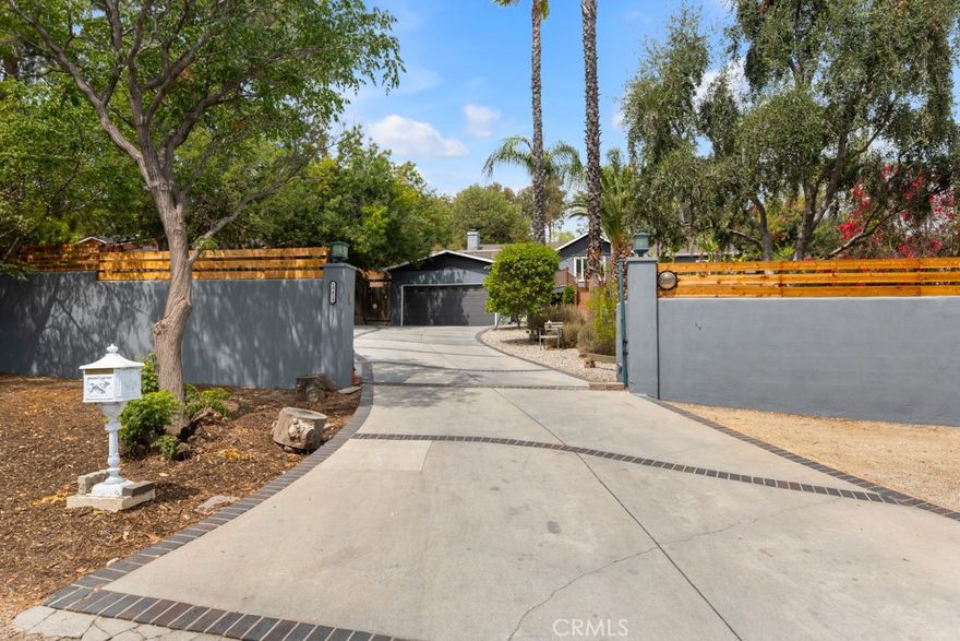 Rustic Charm Meets Modern Living! Beautifully updated home in Melody Acres w/guest house located on a quiet street & elevated with views!  This main residence includes 3 bedrooms, 3 baths, approximately 1,775 sq. ft., thoughtfully refreshed inside and out with all-new double pane windows and doors, a new water main and sewer main, new gutters, and a new tankless water heater—providing peace of mind for years to come. Step into freshly painted interiors with custom finishes & more. The remodeled kitchen is a true chef’s delight, featuring a Viking range and Bosch appliances.  The additional 400 sq ft permitted recreation room/guest house that has its own bathroom and small bedroom is perfect as a guest suite, extended family quarters, or the perfect place to use as a secondary living area/living space.  It's nestled above the main home and is very private and quaint. In addition, a detached office/studio with its own bathroom can serve as a workspace, recording studio, art space, guest quarters, maid's room or man cave. The park like setting in the front yard is surrounded by new drought tolerant landscaping and irrigation, offering beautiful curb appeal as well as the inviting deck perfect for entertaining family and friends.  The back yard has decking throughout as well as a garden room and a storage room. The above ground spa is perfect to unwind.  The property sits on a large lot with all new cedar fencing, professional landscaping & an observation deck to catch the views of the valley. Whether you’re looking for a property with room to grow, space for your animals, or simply a tranquil escape, this Melody Acres compound is a rare opportunity to enjoy the best of both worlds—rustic charm with modern upgrades. Don’t miss this opportunity with endless possibilities to build or expand...Plenty of room for Boat/RV parking. Pool renderings available for a pool & custom BBQ in the back.  Come see this peaceful & private country feel in the heart of the city with views!