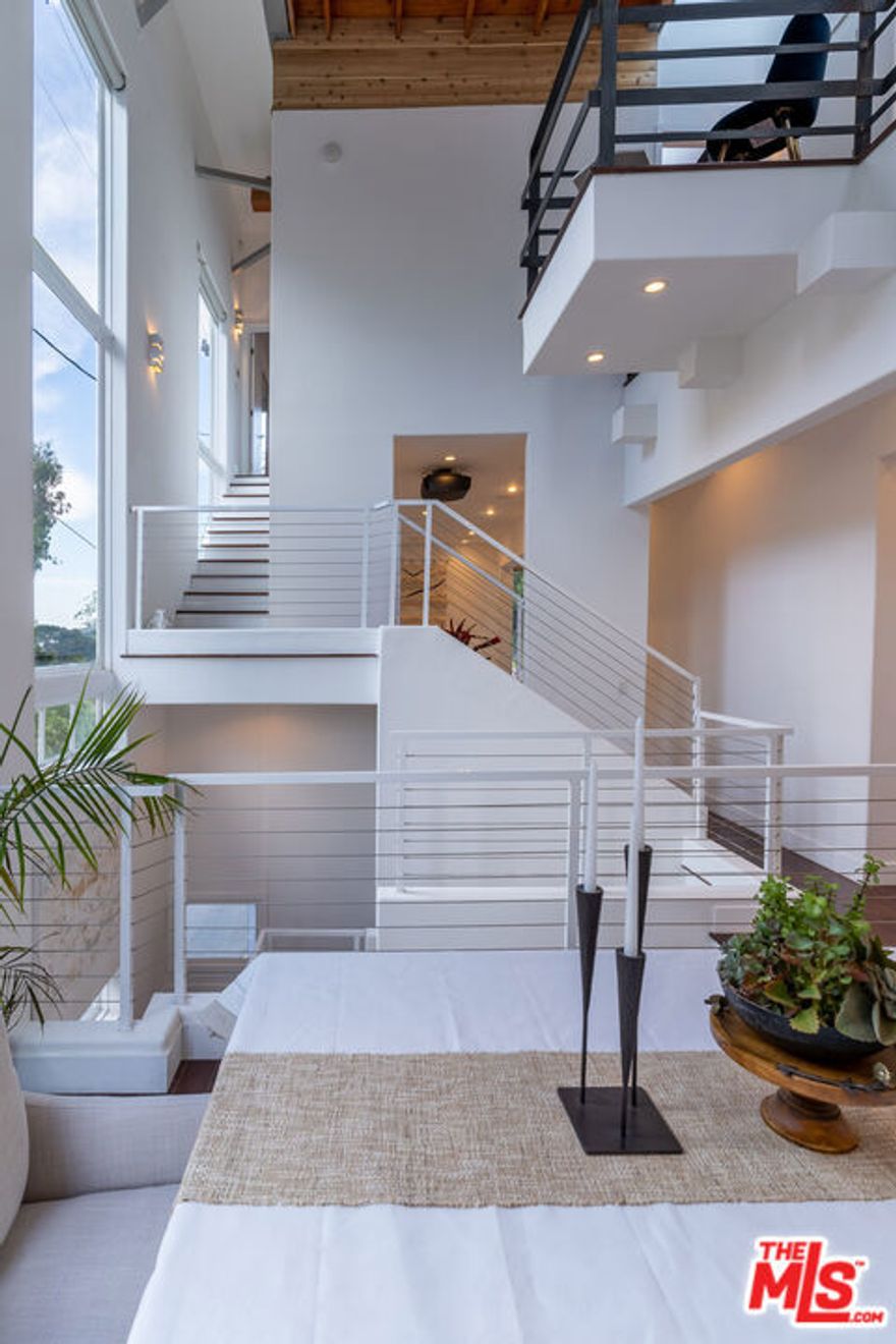 Step into a world of refined luxury at this stunning contemporary retreat, masterfully designed by renowned architect Thomas Mane. This 4-bedroom, 5.5-bath smart home offers a seamless blend of modern elegance and everyday comfort. Newly furnished with curated designer pieces, the expansive living and dining areas flow effortlessly into a tranquil 2,000 sq. ft. garden perfect for both intimate relaxation and stylish entertaining. Designed for ultimate convenience, the home features cutting-edge smart technology including electric blinds, integrated lighting, and premium sound control. A private elevator provides effortless access to every level, while a 3-car garage adds an extra layer of exclusivity. Despite its serene setting, you're just 9 minutes from the iconic Rodeo Drive, where world-class shopping, dining, and nightlife await. Whether unwinding in the garden or enjoying the sleek, modern interiors, this residence is a true sanctuary in the heart of Beverly Hills.