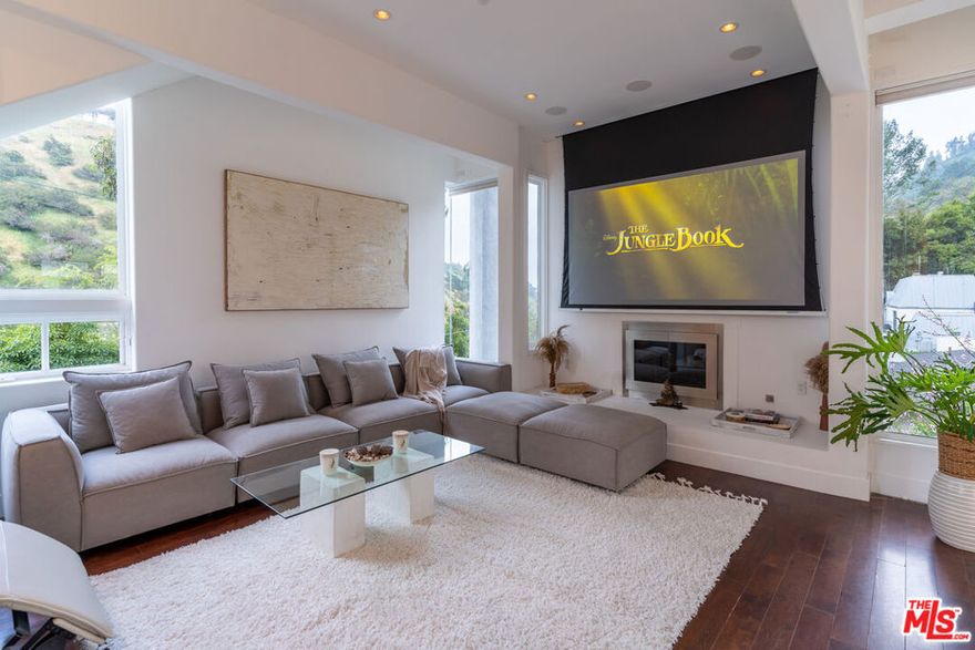 Step into a world of refined luxury at this stunning contemporary retreat, masterfully designed by renowned architect Thomas Mane. This 4-bedroom, 5.5-bath smart home offers a seamless blend of modern elegance and everyday comfort. Newly furnished with curated designer pieces, the expansive living and dining areas flow effortlessly into a tranquil 2,000 sq. ft. garden perfect for both intimate relaxation and stylish entertaining. Designed for ultimate convenience, the home features cutting-edge smart technology including electric blinds, integrated lighting, and premium sound control. A private elevator provides effortless access to every level, while a 3-car garage adds an extra layer of exclusivity. Despite its serene setting, you're just 9 minutes from the iconic Rodeo Drive, where world-class shopping, dining, and nightlife await. Whether unwinding in the garden or enjoying the sleek, modern interiors, this residence is a true sanctuary in the heart of Beverly Hills.