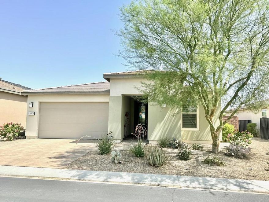 Welcome to the 55+ Community at Trilogy Polo Club! Prepare to be impressed by this beautifully designed home featuring the popular 1,928 sq. ft. Reunion floor plan. Blending elegance, practicality, and flexibility, this layout makes exceptional use of every inch. Boasting 3 bedrooms and 2 bathrooms--with the third bedroom currently configured as a generous den--this home provides space and comfort for modern living. The gourmet kitchen is a chef's dream, complete with a large island that opens to the expansive great room, creating the ideal space for both entertaining and relaxation. The primary suite offers a serene retreat, with a spa like bathroom featuring dual sinks, a seamless glass shower with custom tile and bench seating,  the spacious custom  walk-in closet with a built-in organizer does not disappoint! A second bedroom is thoughtfully placed on the opposite side of the home to enhance privacy. Walls of glass seamlessly extend the living space to a  backyard oasis,  where your relaxing private spa tub awaits. Enjoy the shade under a covered patio outfitted with remote-controlled sun shades--ideal for both entertaining guests and quiet moments of relaxation. This outdoor space is thoughtfully designed with ambient lighting, a cooling ceiling fan, a built-in BBQ, and raised garden beds. Lush tropical landscaping and fruit trees complete the serene, resort-style atmosphere.. Additional highlights include a tankless water heater, roll-out kitchen shelves, ceiling fans, plantation shutters throughout, mini-split A/C in the garage, and built-in garage cabinetry. Best of all, the buyer benefits from full membership at a low transfer fee of $1,875 instead of the full buy-in cost.