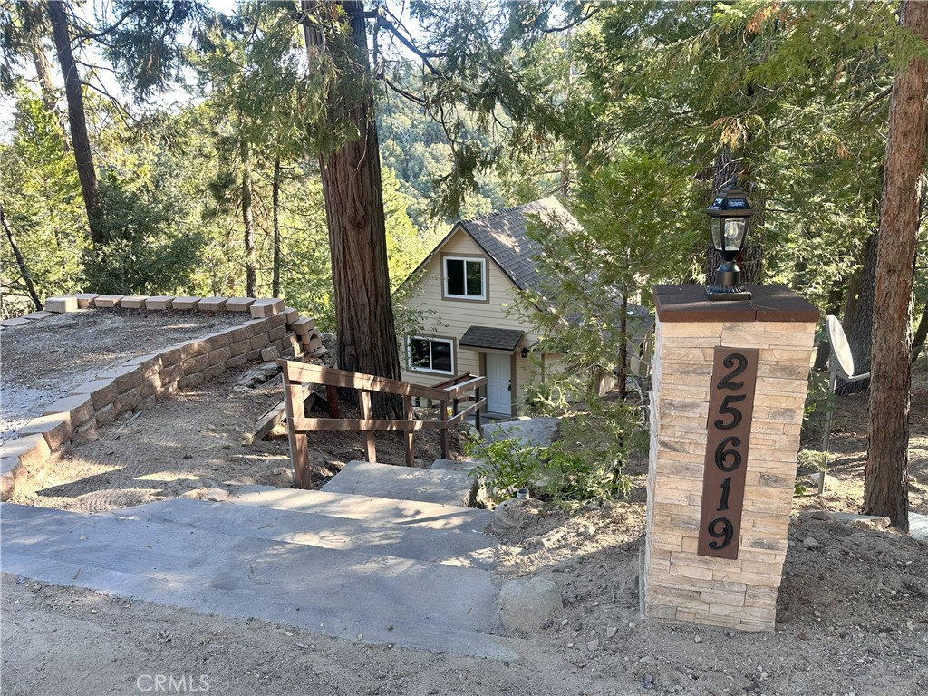 A beautiful mountain gem awaits you! Nestled on a huge private lot. This fully remodeled cabin blends rustic charm with modern comfort. Featuring 3 bedrooms and 2 baths, the thoughtfully designed layout offers both function and flexibility. The brand-new kitchen is a showstopper, boasting quartz countertops, custom self-closing wood cabinets, and stainless-steel appliances—perfect for both everyday living and entertaining. The open-concept kitchen, dining area and family room create a warm and inviting space on the main level. The private master suite is located on the lower level, complete with its own updated bath for ultimate relaxation. Upstairs, the loft serves as a versatile third bedroom or cozy retreat. With plenty of outdoor space to enjoy, this property offers the ideal balance of modern updates and natural surroundings. Enjoy the quiet and peaceful location and it is only 4 miles from Lake Arrowhead Village. Whether you’re looking for a full-time residence, a weekend getaway, or a smart investment, this cabin is a rare find.