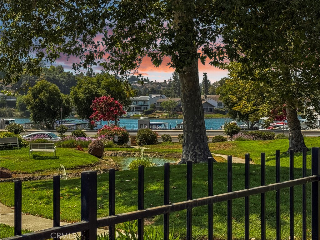 RARE SINGLE-LEVEL 3 BEDROOM TOWNHOME WITH LAKE VIEWS FROM ALL BEDROOMS - in the highly sought-after Summer Shore community, offering one of the best locations with stunning views of serene water features, open green spaces, and Westlake Lake and Marina. This beautiful one-story home features an attached two-car garage, a cozy fireplace in the living room, and a formal dining area perfect for gatherings. The updated kitchen, features granite countertops, newer stainless steel appliances, and a decorative tile backsplash. A cleverly designed kitchen cabinet conceals the washer and dryer for added convenience. The spacious living area boasts a formal dining space just off the kitchen, a fireplace, and two large sliding glass doors leading to a private patio deck with pool view—perfect for entertaining or enjoying serene lake views. Elegant wood shutters are found throughout the home. The primary suite includes a walk-in closet and beautiful lake views, while the secondary bedrooms enjoy views of the lake and/or peaceful ponds. One bedroom features wood flooring, paneled walls, and a built-in bookcase and desk—ideal for a home office or a third bedroom. Additional highlights include tile flooring throughout, a two-car garage, and a community pool and spa close by. Perfectly situated, this home is just steps from the lake, marina, and the vibrant restaurants and shops of The Landing. Enjoy easy access to hiking trails, top-rated schools, and the freeway. This is a rare opportunity to own a move-in-ready townhome in a truly exceptional Westlake Village location.