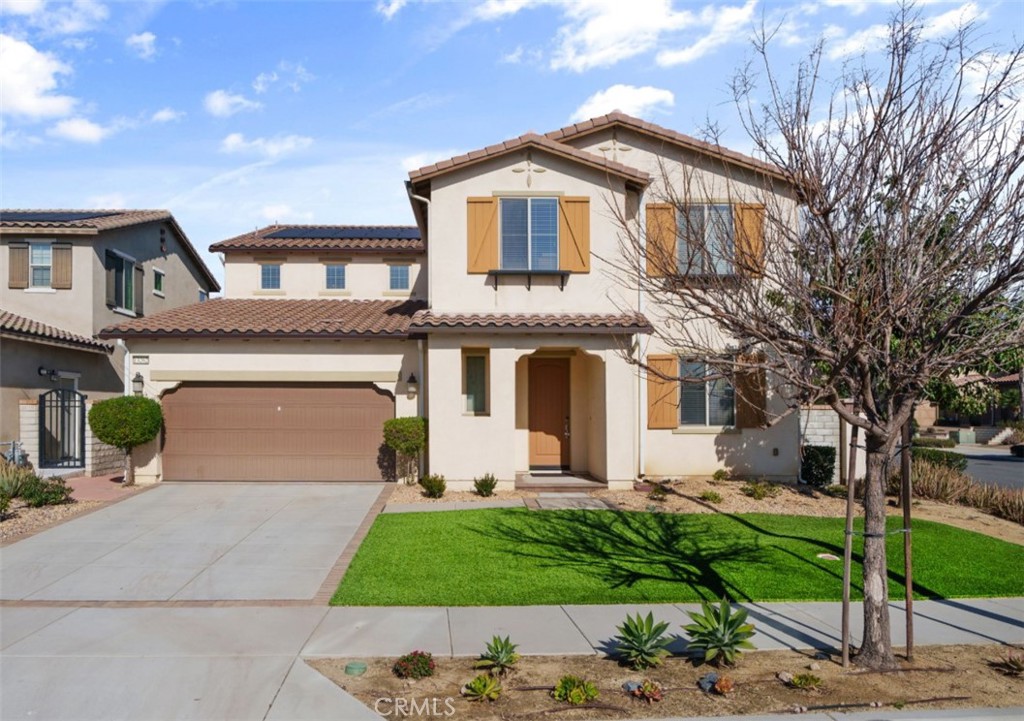 Prime Eastvale Location in the Desirable Estancia Community! Situated on a corner lot, this stunning home offers exceptional curb appeal with lush artificial turf for low-maintenance living. Step inside to a welcoming tile entry that leads to spacious living areas and elegant finishes throughout. The formal living room off the entry can easily serve as a home office or study. A large formal dining room is perfect for entertaining, while the open family room features a cozy fireplace and flows seamlessly into the expansive kitchen. The kitchen is a chef’s dream with granite countertops, an extended island with bar seating, a built-in cooktop, and a double oven. This home also features a downstairs potential NextGen suite, complete with its own kitchen, bedroom, and full bathroom—ideal for guests, multigenerational living, or a rental opportunity. Upstairs, enjoy a spacious loft and a luxurious primary suite with a large retreat area, perfect for relaxing. The primary bathroom boasts dual sinks, a walk-in shower, a soaking tub, a vanity area, and a huge walk-in closet. Three additional bedrooms share a full bathroom with dual sinks. The convenient upstairs laundry room includes built-in shelving for extra storage. Additional highlights include most furniture, solar panels, and crown molding throughout. The beautifully landscaped backyard is perfect for entertaining, featuring a covered patio with a built-in fireplace, stamped concrete, and plenty of space to relax or host gatherings.