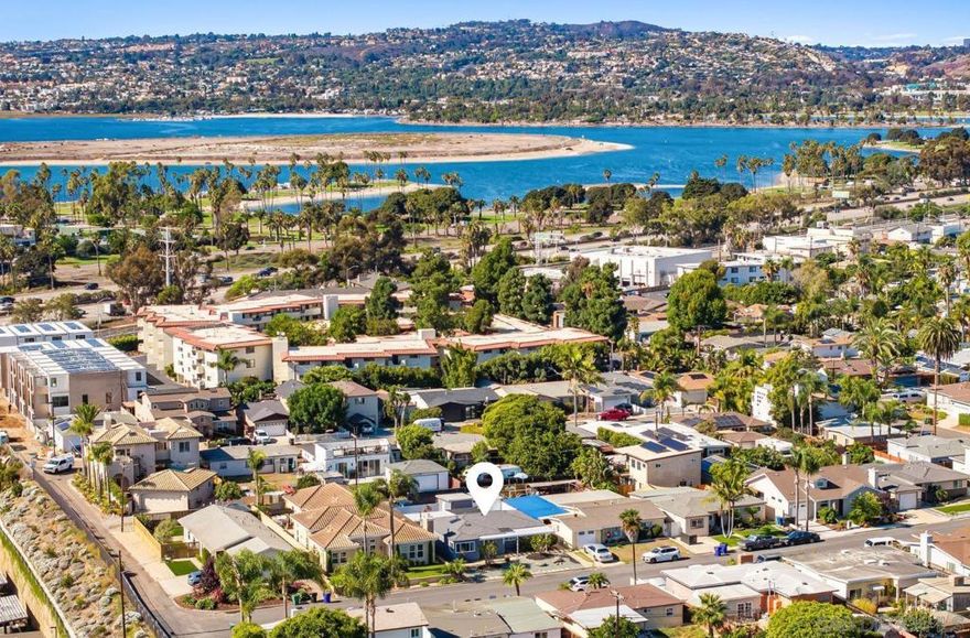 Perched atop the hill overlooking Mission Bay, this fully remodeled Bay Park home defines one of San Diego’s hottest coastal enclaves. Cool bay breezes roll through the living spaces, and the patio delivers front-row views of SeaWorld’s fireworks at night. An oversized great room with a dramatic skylight anchors the 1,442 sq ft single-level layout, flowing into a chef-friendly kitchen finished with stainless appliances, quartz counters, and bar seating. Three restful bedrooms share a crisp, updated bath, while new HVAC, a tankless water heater, and a recent LG washer/dryer keep daily living easy.  Out back, the 5,600 sq ft lot is fully fenced for privacy and secured by an automated gate that opens to a rare three-car parking court. An expansive stone patio invites al-fresco dinners, weekend gatherings, and sunset viewing, all framed by mature landscaping—and those nightly fireworks bursts over the bay. A full-size shed and an additional storage unit handle boards, bikes, and holiday décor with room to spare.  Looking ahead, RS-1-7 zoning allows a detached ADU and/or JADU (buyer to verify), offering income, guest space, or multigenerational flexibility without sacrificing yard. Beaches, the new trolley line, and Bay Park’s buzzing dining scene are minutes away—yet the hilltop perch feels worlds apart.