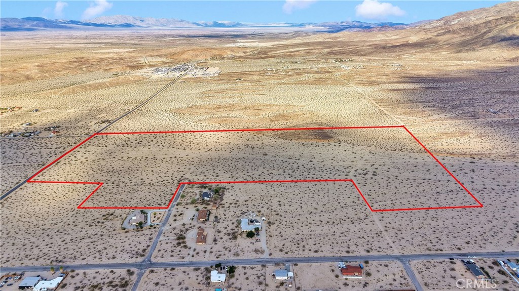 Discover an unparalleled opportunity with this expansive 60-acre property nestled in the captivating desert landscape of 29 Palms PRICED TO SELL!!! On the corner of PAVED Baseline Rd & Wilshire, this pristine land offers endless possibilities, whether you're envisioning a private oasis, an agricultural venture, or a visionary development project. The land could transform into a residential community, mobile home park, eco-friendly lodging, or a thriving commercial hub, capitalizing on the growing interest in this serene area. Its vast open space, combined with breathtaking desert vistas and proximity to Joshua Tree National Park, makes this a truly unique investment opportunity. Embrace the freedom to create your dream and explore the limitless potential this stunning parcel has to offer. While the area may seem rural, this parcel has power poles lined down the main road for close connection, and is adjected to an established housing development, schools, and Joshua Tree park entrance (Utah Trail)