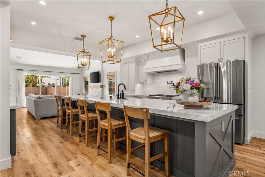 Stunning single story, Eastside Costa Mesa home is among the most beautiful on the market. Fully renovated, with an exceptionally large lot, pool and spa. It’s as close to new construction as you’ll find. Built in 1978, remodeled down to the studs in 2020 with nearly every surface touched, replaced or renovated. Exceptional in craftsmanship, quality and design, the open floorplan brings the kitchen, dining and great room into focus. A beautiful kitchen was made for gatherings with a 15’ island, porcelain slab bookmarked counters, modern shaker style cabinets, designer fixtures, lighting and more. It all opens to an expansive yard with a patio, pebble tech pool, spa and sports court. Inside, the primary suite is airy with natural light, vaulted ceilings and a customized walk-in closet. Its en-suite bath was also entirely redesigned and customized. This three-bedroom home also offers a separate office (possible fourth bedroom), and dedicated laundry room. Renovations also included new Marvin windows, PEX plumbing, upgraded electrical, new roofing, HVAC, lighting, landscape, hardscape, and so much more. Creative team included Serendipite Designs, Vulkan Architects, and C. Jones & Company.