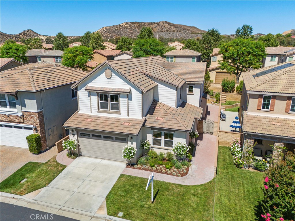 Discover this hidden gem in the highly sought-after West Creek community of Valencia. This stylish 4-bedroom, 3-bathroom home with a spacious loft offers over 3,060 sq. ft. of refined living.
Freshly painted and move-in ready, the flexible floor plan includes a first-floor bonus room—ideal for a 5th bedroom, office, or playroom—a generous loft, and a 3-car garage. Thoughtful upgrades throughout include rich wood flooring, designer tile, plantation shutters, dual-zone A/C, surround sound, a tankless water heater, a cozy gas fireplace, and ceiling fans.
The gourmet kitchen is a true entertainer’s dream, featuring GE Monogram appliances, an oversized island with seating, a butler’s pantry, full-wall pantry, built-in tech center, and a convenient mudroom. Upstairs, the loft separates the bedrooms, creating privacy for the entire family.
The luxurious primary suite offers a serene retreat with dual vanities, a soaking tub, walk-in shower, and an expansive custom closet with its own dressing area. Three additional bedrooms include walk-in closets and share a dual-vanity bathroom.
Step into your private backyard oasis, complete with a covered patio, lush landscaping, and plenty of space for both relaxation and entertaining.
Perfectly located near scenic walking trails, award-winning schools, shopping, dining, parks, a clubhouse, and three resort-style community pools, this home blends comfort, convenience, and lifestyle.
Bring the whole family—including your four-legged friends—and start making unforgettable memories. Welcome home!