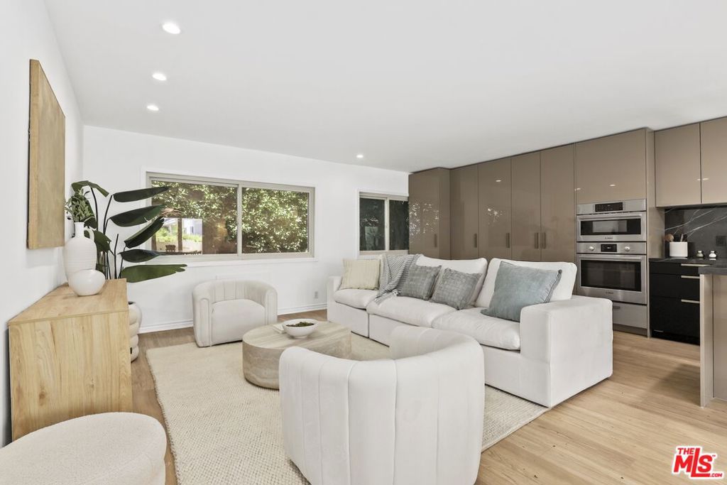 Welcome home to your Palm Springs like resort in the heart of West Hollywood. This beautifully renovated two-bedroom, two-bath residence features a reimagined Poggenpohl kitchen with new cabinets, appliances, countertop, backsplash, and a spacious kitchen island, complemented by a new Miele dishwasher. Brand new interior doors, new flooring, a new front door, and upgraded recessed lighting throughout elevate the home's modern appeal. The residence is further enhanced with a new Renewal by Andersen sliding door, and new windows and screens, filling the space with natural light. Positioned in the quiet rear of the complex, the living area and patio overlook the sparkling pool, while the primary bedroom offers a serene retreat tucked away for ultimate privacy. Just one block to Trader Joe's and the neighborhood pharmacy, and two blocks to Bristol Farms and Whole Foods, you'll enjoy unmatched convenience. Local favorites such as Laurel Hardware, Tu Madre, and Connie & Ted's are all just moments away, along with the vibrant restaurants and nightlife that define West Hollywood living. Set within a classic mid-century building, residents are welcomed by a striking terrazzo-tiled entry and can indulge in the resort-style pool and lounge area, complete with swaying palm trees, chaise lounges, and umbrellas, the perfect blend of style and relaxation.