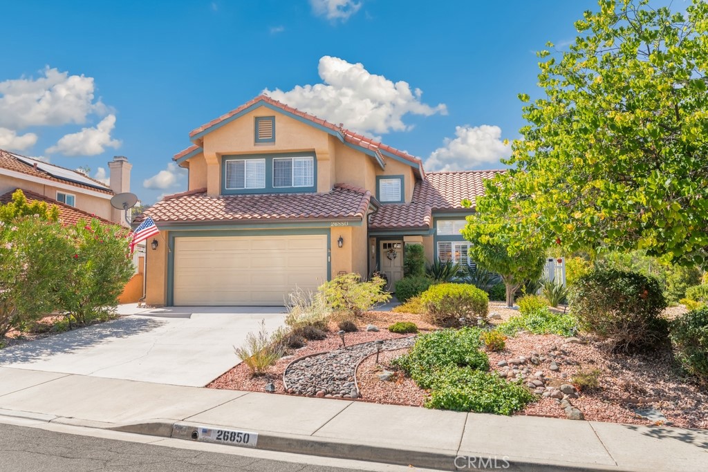 Beautifully updated home in a desirable cul-de-sac location with stunning hill views! This property boasts a bright, open layout with vaulted ceilings, bamboo flooring, and elegant wood shutters on the windows. The spacious living and dining rooms off the entry flow seamlessly into the family room, where a cozy fireplace with tile surround and mantle creates the perfect gathering spot. The kitchen offers a breakfast nook, warm wood cabinetry, and an open design to the family room for easy entertaining. Upstairs, find 3 bedrooms and 2 bathrooms, including a newly upgraded primary suite featuring a huge tiled shower, dual closets (one walk-in), and modern finishes. Additional highlights include a new A/C, new water heater, epoxy garage floors, and a HAP water filtration system. The backyard is a true retreat with low-maintenance artificial turf, a covered patio, and peaceful views of the hills. With a direct access 2-car garage and a convenient location close to local schools, shopping, dining, and the 215 freeway, this home combines comfort, style, and everyday convenience.