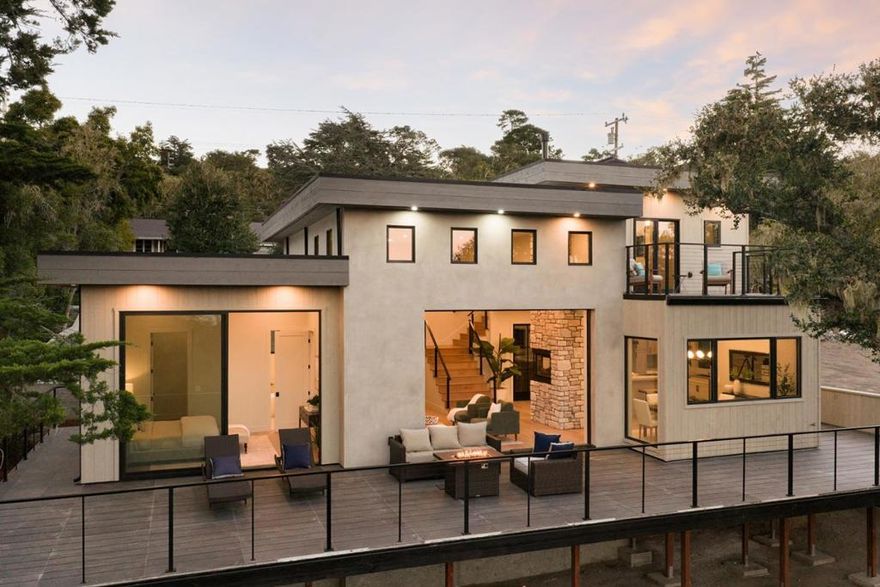 This stunning, brand-new modern home is located in the peaceful Carmel Woods neighborhood, just minutes from downtown's shops, restaurants, and beaches. The 3-bedroom, 2.5-bath residence offers 2,244 sq ft of light-filled living space on a ~10,000 sq ft lot. The spacious living room, featuring a striking tri-sided gas fireplace, opens onto a large deck that overlooks the tranquil forest. The beautiful gourmet kitchen includes a large island with a breakfast bar, high-end appliances, a wine closet, and an adjacent dining area. The main-level primary suite with deck access includes a walk-in closet with laundry hookups, and a spa-like bathroom with radiant heat flooring, dual sinks, soaking tub, and custom shower. Upstairs are two bedrooms with balconies, a shared bathroom, laundry hookups, and peeks of the ocean. Additional highlights include high ceilings, a stucco and cedar exterior, solar panels, an attached 2-car garage, and a large pavered driveway with additional parking space. This is an exceptional opportunity for a brand-new, turn-key home in Carmel.