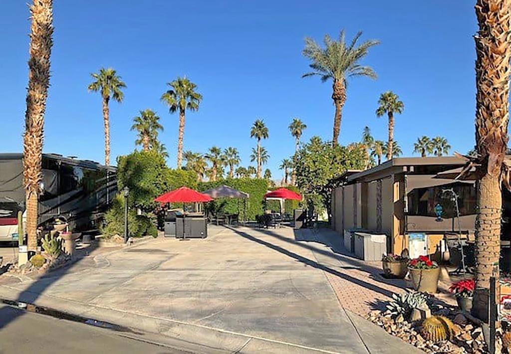 Step directly from your backyard onto the 14th tee and immerse yourself in a golfer's paradise, seamlessly combining luxury living with your love for the game. Lot #159 at Outdoor Resort Indio is perfectly positioned to enjoy the best of resort living, with an east-facing orientation that offers stunning views of the golf course, a tranquil pond, and a sparkling fountain. The serene surroundings create the ideal backdrop for both relaxation and recreation, making every day feel like a getaway.This fully furnished lot is designed for outdoor living, featuring a well-equipped kitchen with a sink, hot water, garbage disposal, dishwasher, and ample storage. Cook and dine alfresco with a stainless steel BBQ with rotisserie, a 2-burner cooktop/griddle, and a new dining table for six under a lighted gazebo with a new Sunbrella top and a table for four up front. Relax in style with brand-new furniture, including a loveseat, two chairs, a coffee table, and an outdoor TV with a protective cabinet. Additional conveniences include an outdoor heater, two umbrellas with bases, a deck storage box, and three large planters with irrigation. With a completed survey for potential improvements (a $1,200 value), this lot offers both comfort and opportunity, making it the ultimate luxury RV destination.Please note: the clubhouse assessment is paid for.‍
