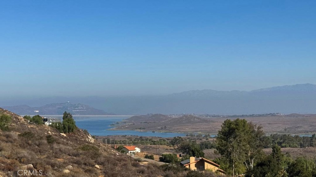 OPPORTUNITY KNOCKS - This LAKE MATTHEWS HOME has PANORAMIC VIEWS of the Lake, Beautiful Hills and Surrounding Mountains!! Situated on a GIANT 3 ACRE Lot - This Home Offers a 842sqft WORKSHOP/Garage with a Private Bathroom, 4-STALL Barn with Tack Room, Separate ART STUDIO or Fitness Room, Storage Sheds, Chicken Coop & Animal Pens and a GIANT Covered Patio with BBQ Island and ENDLESS VIEWS...PERFECT FOR ENTERTAINING!! There's Plenty of Room for your HORSES, Trucks & Trailers and Room to Add an ADU/2nd Unit Possibly!! This SPACIOUS Home offers 1861sqft with 3 Bedrooms and 2 Bathrooms and is READY for your Finishing Touches * * Large Kitchen has Stainless Steel Appliances, Granite Counter Tops and Breakfast Nook * * Living Room has SLATE Tiled Flooring Throughout, Large PICTURE Windows, Built-In Media Center and a Wrap Around Deck to Enjoy the SERENE VIEWS * * Terrific Master Bedroom has your own Balcony and Private Master Bathroom * * Separate Patio/Sun Room * * Indoor Laundry Room with Pantry Storage * * Attached Covered Carport * * Secluded Area with Oak & Sycamore Trees, Seasonal Stream and Plenty of Nature Scape to Enjoy * * THIS HOME HAS ENDLESS Possibilities - Make this a MUST SEE - Seller is Motivated - Submit Your Offer!!