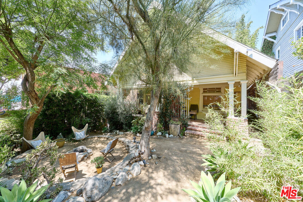 Nestled just 1.5 blocks from the beautiful Echo Park Lake, this unique Craftsman compound offers the perfect blend of character, comfort, and versatility for creative professionals and families alike. Set behind lush bamboo for privacy and natural shade, this 3-bedroom, 2-bathroom main residence is full of original charm rich wood floors, handcrafted millwork, and a cozy fireplace create a warm, welcoming atmosphere.The thoughtfully updated kitchen features a vintage-style farmhouse sink, custom tile, and butcher block countertops ideal for family meals and culinary creativity. A beautifully restored bathroom with beadboard and penny tile maintains the home's classic character, while the spacious layout and original detailing invite both connection and calm.Designed for both inspiration and play, the outdoor spaces are a true retreat: a private front yard with a fire pit, a large backyard deck for entertaining, and an outdoor shower with a clawfoot tub perfect for post-park rinses or stargazing soaks. Children can explore the lush landscape filled with mature trees, while parents enjoy a thriving garden with rosemary, thyme, and an impressive lineup of fruiting trees; fig, lime, apricot, mango, pomegranate, and a nearly-fruiting avocado.Ideal for creative parents working from home, the detached skylit office with recessed lighting provides a quiet, focused space to work or dream. A charming guest quarters with its own private outdoor area beneath a bamboo and ivy pergola is perfect for visiting family, in-laws, or an au pair. A custom shed adds functionality and extra storage for art supplies, bikes, or gardening tools.The gated two-car parking with alley access via a motorized gate adds convenience and security, and the location provides quick access to the 101, as well as the best of Echo Park's cafes, shops, and community amenities.Please note: the main home is currently tenant-occupied but can be delivered vacant at the close of escrow, offering full flexibility for the next owner.Whether you're a filmmaker, designer, writer, or creative entrepreneur raising a family, this rare Echo Park offering is a turnkey opportunity to live, work, and grow in an inspired environment.