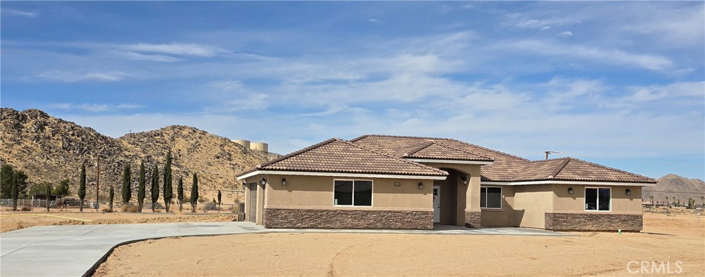 Stunning New Construction Home. Discover this brand-new home in the highly desirable area of Apple Valley. Situated
on over an acre of land, this home offers plenty of space and privacy while remaining close to modern conveniences.
Featuring 5 spacious bedrooms and 3.5 bathrooms, the thoughtfully designed split floor plan includes a mega kitchen
with abundant cabinetry, a walk-in pantry, and magnificent countertops with a center island—perfect for entertaining.
The expansive living and dining areas flow effortlessly into a separate family room with a charming fireplace, creating a
warm and inviting atmosphere. Retreat to the spacious master suite, which boasts an oversized bathroom with dual
sinks, a separate walk-in shower, a relaxing garden tub, and a huge walk-in closet. Enjoy low electricity costs with fully
paid solar, and take advantage of the home’s prime location—just minutes from shopping, schools, and easy highway
access. Outdoor lovers will appreciate being only minutes from Hesperia Lake and the mall, while a short drive takes
you to Lake Arrowhead and Silverwood Lake for weekend getaways. Plus, exciting developments are coming to the
High Desert! The proposed Brightline Bullet Train station is set to enhance local connectivity, making this an even more
attractive place to call home. Don’t miss out on this fantastic opportunity to own a brand-new home in a growing and
sought-after location!