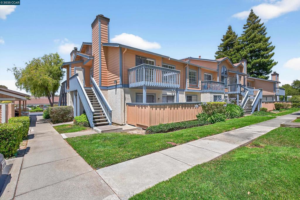 Top-floor end unit nestled in one of Hercules' most desirable communities. Bathed in natural light, the spacious living room boasts tall ceilings, a cozy wood-burning fireplace, and direct access to a private balcony overlooking lush greenery, ideal for relaxing or entertaining. The kitchen is a standout, featuring sleek quartz countertops, modern stainless steel appliances, a deep sink with updated fixtures, refinished cabinetry, and new flooring. The primary bedroom is a peaceful retreat with vaulted ceilings, dual closets, and a private powder room. A generously sized second bedroom offers plenty of storage, perfect for guests or a home office. Additional highlights include in-unit laundry hookups and dedicated parking with ample guest spaces. Just steps from the sparkling community pool, and conveniently located near scenic walking trails, parks, dining, shopping, public transportation, and major freeway access, this home offers the ideal blend of comfort, style, and convenience for Bay Area commuters.