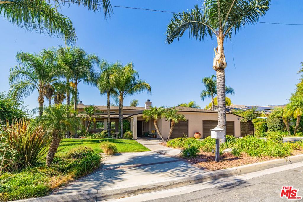 Experience the best of Southern California living in this beautifully designed 3-bedroom, 2.5-bath home that blends comfort, style, and effortless indoor-outdoor living. The formal living room welcomes you with soaring ceilings, clerestory windows that flood the space with natural light, and glass doors that open to the patio overlooking the pool. An elegant fireplace adds warmth and charm. The chef's kitchen is equipped with an oversized built-in refrigerator, a five-burner stovetop, and a built-in microwave and oven. Custom brick flooring and rich wood cabinetry create a timeless sense of warmth and sophistication. The open floor plan flows seamlessly into the family room with a fireplace and the dining area, perfect for gatherings. A conveniently located powder room serves guests with ease. The primary suite is a peaceful retreat featuring a private garden-view patio, a large dual-sink vanity, a soaking tub, and a spacious walk-in closet. Two additional bedrooms provide ample space and direct access to the garden, along with a shared guest bath. Step outside to your private backyard oasis with a sparkling pool, covered patio with ceiling fans, and breathtaking city-light view for entertaining or quiet evenings at home. The finished three-car garage with built-in cabinets offers exceptional storage and convenience. This home is the perfect blend of functionality, elegance, and California lifestyle, a true haven for everyday living and memorable gatherings.