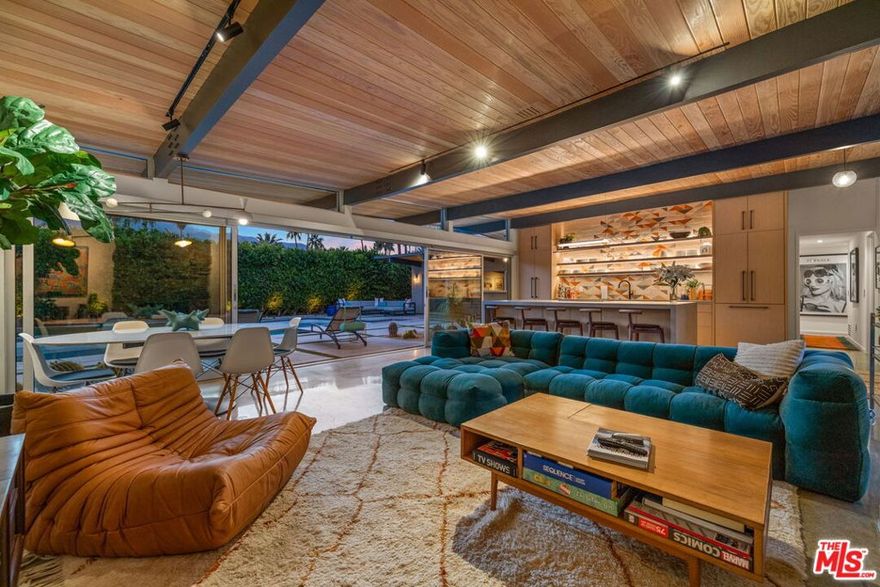 AVAILABLE starting Mid-SEPT. 2025 thru MAY 2026 | Iconic Style, Modern Luxury Seasonal Rental in Central Palm Springs. Step into the Palm Springs dream with this meticulously remodeled 1958 Alexander, where iconic mid-century modern design is seamlessly elevated with today's luxuries. Situated on a private corner lot in the heart of central Palm Springs, this 3 bed | 3 bath home offers jaw-dropping views of the San Jacinto mountains and the ultimate seasonal escape. A gated courtyard with fire pit and lounge area sets the tone for desert living at its finest. Inside, a dramatic double-door entry opens to walls of glass framing the sparkling pool, lush landscaping, and endless skies. The open-concept floor plan with vaulted ceilings creates a light-filled space ideal for entertaining. The designer-renovated kitchen features a custom island, professional-grade appliances, built-in refrigerator, and striking tile backsplash. The principal suite includes a cozy sitting area with fireplace, roller shades, and direct pool access. Newly remodeled bathrooms showcase Zia Cantera Tile, custom cabinetry, and modern fixtures, blending style and comfort. Each guest bedroom offers its own private outdoor patio, while the home is equipped with TVs in all bedrooms and the main living area for convenience. Outdoors, relax on the tanning shelf of the sparkling pool, unwind in the inset spa, or gather with friends around fire features. An outdoor bar, BBQ, covered dining patio, and multiple lounge zones create an entertainer's paradise. Mature hedges, swaying palms, and desert plantings provide resort-like privacy. Additional highlights include a rock-faced indoor fireplace, interior laundry, and ample space to host or simply relax. Just minutes from downtown Palm Springs, this home delivers everything a seasonal renter desires: iconic architecture, resort-style amenities, privacy, and unbeatable location. Escape the cold and indulge in your slice of Palm Springs paradise. HURRY THIS ONE WON'T LAST!