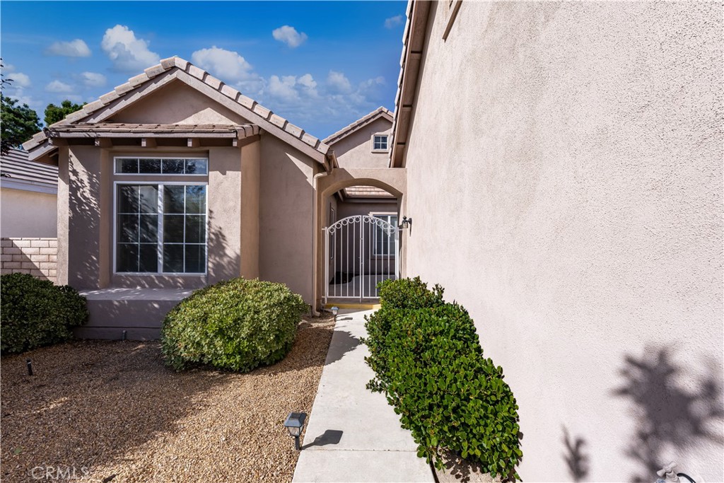 This inviting Apple Valley home combines comfort, convenience, and energy efficiency with fully paid solar panels, with savings of $363/month for the new buyer. Located in the desirable Wyndham Gated community, designed for easy living and enjoyment. The heart of the home is a spacious open living area, filled with natural light from large windows and accented by high ceilings and a cozy fireplace. It flows seamlessly into the dining space and kitchen, making it perfect for gatherings with friends or quiet nights in. The primary suite offers a peaceful retreat with a roomy walk-in closet and spa-inspired bath featuring a soaking tub, separate shower, and dual sinks. A second bedroom, also generously sized with its own walk-in closet, provides comfort for guests or family. TWO 10X10 additional bonus rooms adds flexibility—ideal as a home office, mud room, craft space, or cozy den. Outside, the low-maintenance yard with patio and mountain views makes it easy to enjoy Apple Valley’s beautiful surroundings without the extra upkeep. Other highlights include a 2-car garage with plenty of built-in storage, 2 year old HVAC, Water softener. With shopping, dining, entertainment nearby, and the Mojave River and main roads just minutes away—you’ll love the combination of privacy and convenience this home offers.