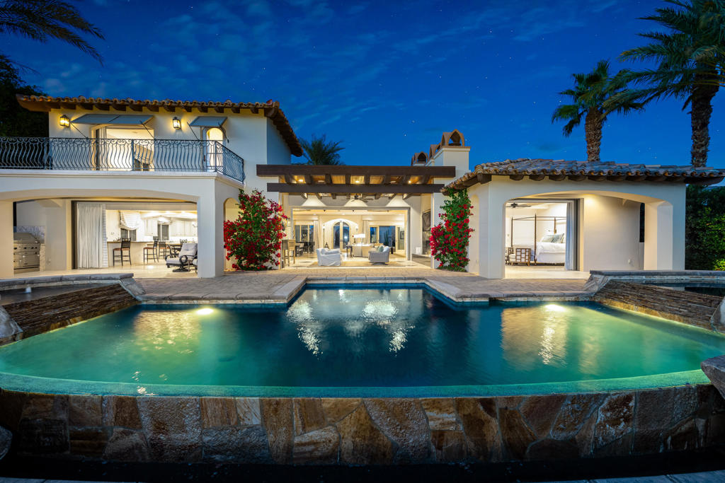 Sought after prime South facing location on this custom estate at the Hideaway! Four bedrooms, four baths and two powder rooms including a two room casita. Approx. 5,280 sq. ft. on prime .34 acre lot. Features beautiful courtyard entry with stone fireplace and water feature. Double door entry to foyer and great room with fireplace, media and formal dining area. Oversized gourmet kitchen with center island and breakfast bar adjacent to family room with amazing custom bar with media that opens to the outside patio. Updated to perfection with custom finishes including sliding pocket doors imported from Portugal and more! Large master suite with fireplace, media and spa inspired bath with glass shower and jet tub. Guest accommodation include a two room, casita with living room and kitchenette. Pocket doors open to an outdoor living room with fireplace and media. Fire pit and custom infinity pool with tanning shelf, double waterfalls and raised spa. All this plus the most stunning south facing views of lake, and mountains located between the 13th & 14th fairways of the Pete Dye course! Offered furnished per inventory. Hideaway membership is separate with sale.