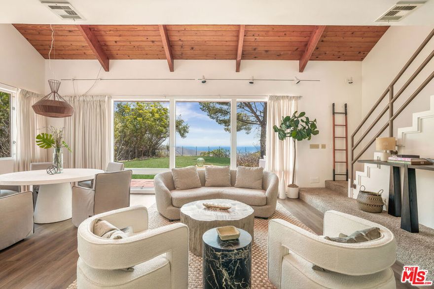 Discover this rare Malibu retreat, a 3-bedroom, 2-bath single-family home with breathtaking ocean views, set on a private one-acre plus lot (45,097 sq ft) at the end of a secluded street. Built in 1974, the 1,484 sq ft residence blends vintage Malibu character with modern potential. Expansive windows flood the home with natural light, framing views of the Pacific and the surrounding canyon where hawks and owls glide above fresh wildflowers. The primary suite opens to a spacious ocean-view balcony, perfect for relaxing and taking in Malibu's sunsets. A large, flat area on the property offers exceptional privacy and space for outdoor living, gardens, or potential future expansion. Additional features include a two-car garage and a peaceful location just minutes from Malibu's most beloved beaches at La Costa Beach, Big Rock, the Barefoot Bar at Duke's, as well as the Pacific Coast Highway for easy access to Santa Monica and beyond. Live the Malibu lifestyle: ocean breezes, nature's beauty, and the timeless soul of the 70s.