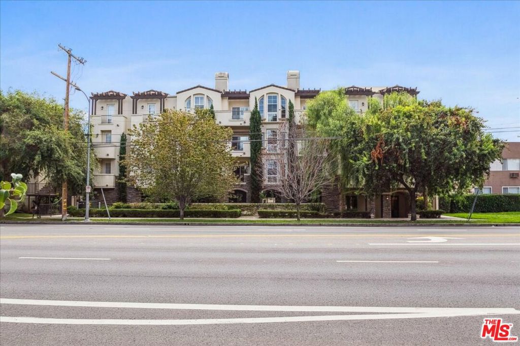 Welcome to 14242 Burbank Blvd #103 a beautifully designed luxury condo tucked away from the busy street, offering privacy and comfort in the heart of Sherman Oaks. Welcome inside to an open-concept floor plan filled with natural light. The spacious living room flows seamlessly into the dining area and modern kitchen, perfect for both everyday living and entertaining. Gorgeous wood flooring runs throughout the home, adding warmth and sophistication. The kitchen boasts granite countertops, a stylish breakfast bar, and ample cabinetry, making it both functional and inviting. Two generously sized bedrooms sit on opposite sides of the unit for ultimate privacy. The primary suite features a spa-like bathroom with dual sinks, a large walk-in shower, and a separate Jacuzzi tub for relaxation. Additional features include recessed lighting, an in-unit washer and dryer, a private balcony ideal for morning coffee or evening unwinding, and a cozy fireplace for those chilly nights. The building offers fantastic amenities, including a rooftop patio with stunning 360-degree mountain and tree views, a recreation room with pool and game tables, a fitness area, guest parking, and two dedicated gated parking spaces. Conveniently located near Westfield Fashion Square, local restaurants, and with easy access to the 101 and 405 freeways, this 2007-built condo is truly a gem. Elevator access included. Don't miss this incredible opportunity to call Sherman Oaks home!