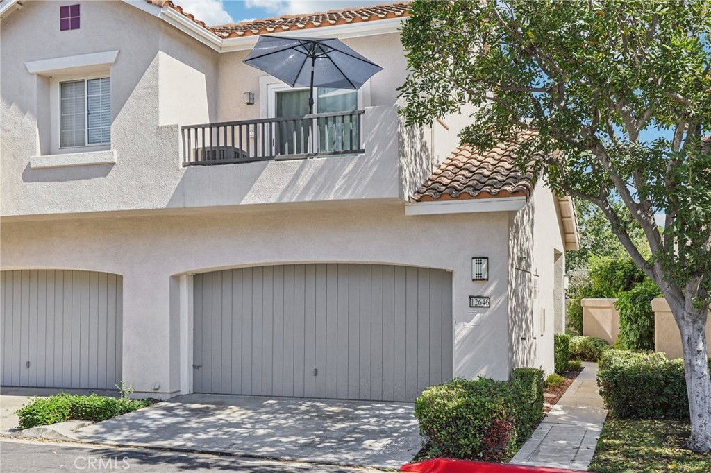 Welcome to this inviting end-unit townhome in the Ventana community of Tustin. With hardwood floors, the open floorplan feels bright and welcoming from the moment you walk in. The living room features a cozy stone-tile fireplace, and the kitchen offers granite counters, white cabinets, stainless steel appliances, and a breakfast bar that flows right into the dining area. Sliding doors open to the private backyard, creating a great space for BBQs, morning coffee, or relaxing evenings outdoors. A powder room and full-size laundry closet add everyday convenience on the main level. Upstairs, the primary suite has vaulted ceilings, a walk-in closet, and a dual-sink vanity in the en-suite bath. Two additional bedrooms share a hall bath and provide plenty of space for family, guests, or a home office. The attached two-car garage is finished with built-in storage. The wraparound backyard is upgraded with stamped epoxied concrete and low-maintenance landscaping, giving you a private outdoor retreat. Plus, you’ll enjoy access to Greenway Park with its pool, spa, tennis courts, tot lot, and picnic area—perfect for staying active or connecting with neighbors.