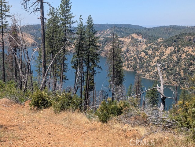 Attention outdoor lovers, builders, and investors—this is the opportunity you've been waiting for! Welcome to your very own 5.00-acre slice of Northern California paradise, offering stunning mountain and lake views, peaceful rural surroundings, and unbeatable privacy—all behind secure, locked gates for maximum exclusivity. Whether you're looking to build a dream home, a weekend retreat, or secure a long-term investment in one of the most scenic regions around, this property checks every box. Breathtaking panoramic views of the surrounding mountains and nearby lake create a truly one-of-a-kind backdrop that few parcels can offer. The land is raw, ready, and bursting with potential. Imagine building a custom cabin, an off-grid modern hideaway, or even a glamping site—this parcel is your blank canvas. There's plenty of usable space, room for toys, trails, gardens, or even a guest house. With 5 full acres to call your own, you'll enjoy peace, space, and the flexibility to make this land work for your unique vision. Location matters—and this one delivers! The property is tucked away for privacy, but still close enough to local amenities when you need them. The locked gate access adds an extra layer of security, making it ideal for those seeking solitude, investment potential, or a protected space for recreation and retreat. Whether you're planning a weekend escape, year-round living, or an income-generating short-term rental site, this is a golden opportunity to secure your own piece of California mountain magic. With inventory low and buyer interest high, land like this is disappearing fast—especially parcels with this much character, space, and jaw-dropping views. Ready for a new vision. Ready for a new home. Ready for YOU. Don’t wait—this property offers serious value and won’t stay on the market long. Come explore the possibilities and make this remarkable 5-acre lot yours before someone else does! Schedule your viewing today and bring your dreams to life! The MLS photos may not be of the actual property, but photos of the area around the property.
