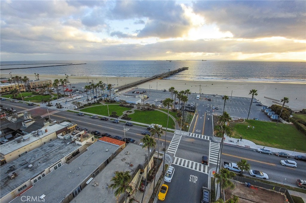 Welcome to Coastal Living in the Heart of Old Town Seal Beach!
Just steps across the street, you’ll find yourself immersed in the majestic ocean waters that set the stage for your best life at the beach, toes in the sand and moments away from charming restaurants and quaint boutiques.This second floor home greets you with a front door that frames a beautiful ocean view. Inside, the spacious, open concept living room and kitchen create the ultimate space to entertain guests. A custom made beer keg bar adds a unique touch for memorable gatherings, while a cozy fireplace makes the perfect backdrop for relaxing winter evenings.The kitchen is thoughtfully appointed to inspire any chef, featuring granite countertops, double ovens, a warming drawer, and ample space for culinary creativity. Retreat to the luxurious primary suite, where the spa like bathroom offers heated floors, a warm towel rack, a fireplace shared with the bedroom, and an indulgent jetted tub and shower with multiple spray heads, true luxury at its finest. Additional amenities include an in-unit stacked washer and dryer. To service persons with disabilities a "LIFT", conveniently transports to and fro the 1st and second floor. Garage tandem parking for two cars is an added plus to living in Seal Beach. Experience the ultimate in beachside living!!