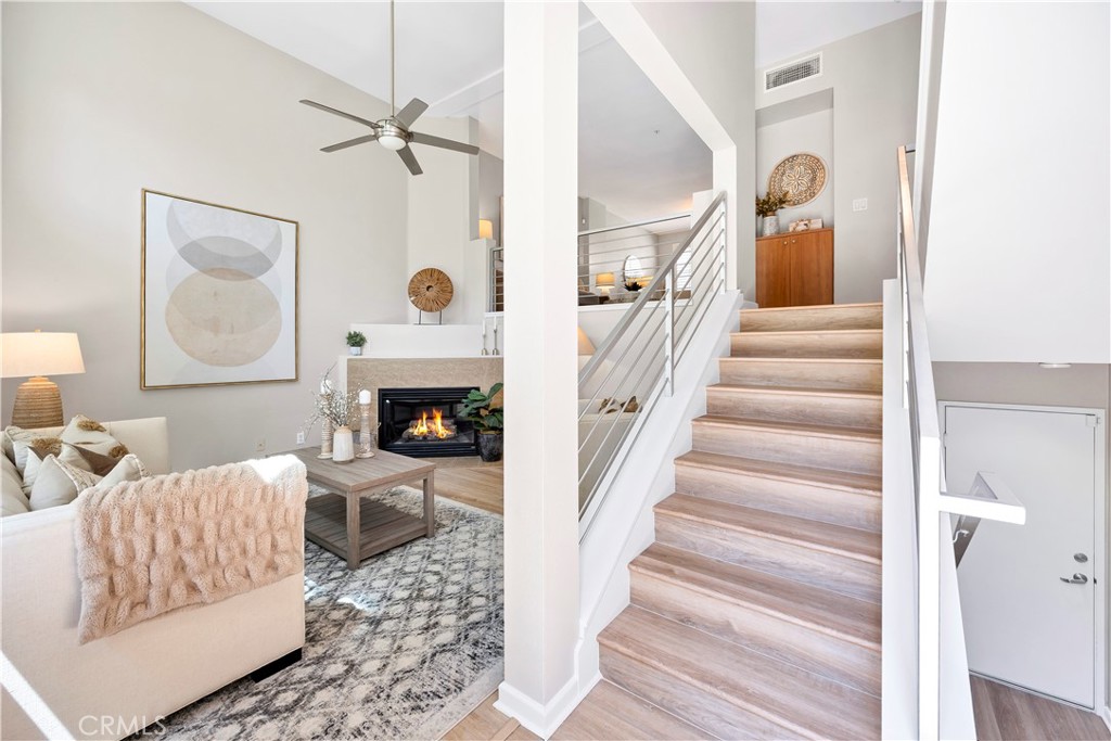 Discover the perfect blend of comfort, style, and convenience in this stunning multilevel townhouse located in the heart of one of Orange County's most vibrant communities. This expansive 3-bedroom, 2.5-bathroom residence features a versatile bonus 4th room with a closet—ideal as a bedroom, home office, guest space, or playroom—and boasts a generous 2,185 sq ft floor plan, making it one of the largest in the area. Newly upgraded with beautiful LVP flooring and fresh paint, this home is ready for you to move in and make it your own! As you step inside, you’re greeted by an inviting formal living space adorned with a cozy gas fireplace, seamlessly flowing into the open living and dining areas—a perfect setting for entertaining family and friends. The modern kitchen is a chef's dream, showcasing granite countertops, stainless steel appliances, and ample storage, all while being perfectly situated to allow for easy conversations with guests in the dining room. A conveniently located half bath rounds out this level, making gatherings a breeze. Venture to the third floor where you’ll find two generously sized bedrooms and Bonus Room. A spacious laundry room and a stylish bathroom complete this level, featuring dual sinks for added convenience. Retreat to the fourth floor where the luxurious master suite awaits, featuring a large walk-in closet and a bright, airy bedroom. The en-suite bathroom is a true sanctuary, complete with a soothing soaker tub and a separate shower—perfect for unwinding after a long day. City Place is not just a home; it’s a lifestyle. Enjoy beautifully landscaped areas, and take advantage of the proximity to Santiago Park, popular dining spots like Mother's Market, Habit Burger Grill, and The Olive Garden, as well as your favorite coffee shop, Coffee Bean. With easy access to major highways (I-5, 57, and 22) and just a short drive from the revitalized Downtown Santa Ana, this location offers the perfect balance of tranquility and urban excitement.