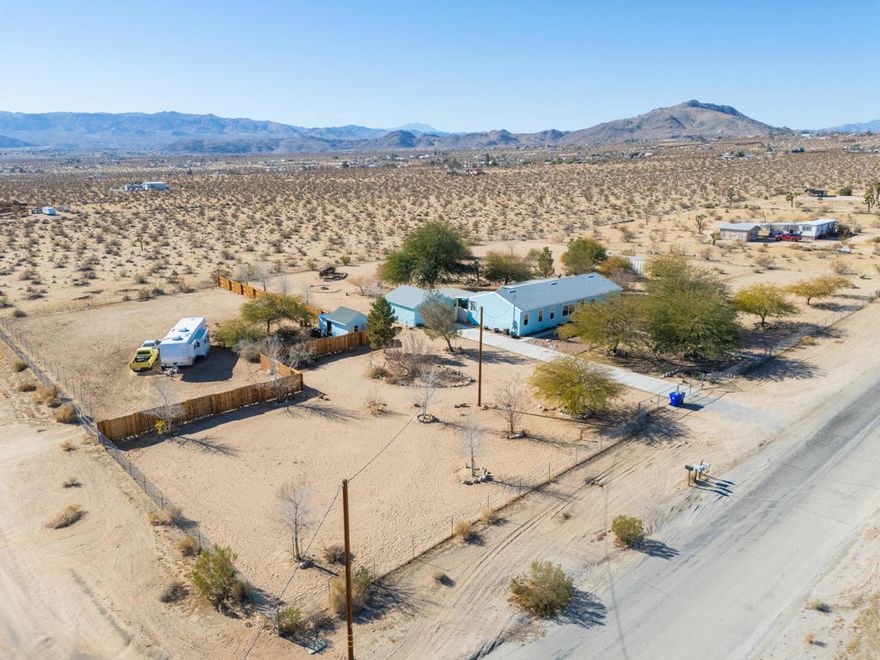 Welcome to this stunning 4-bedroom, 2-bathroom home with 1,980 SQ FT of living space, set on 2.38 acres of fenced high desert land in Joshua Tree. Featuring a spacious master bedroom with a remodeled en-suite, a beautifully updated kitchen and guest bath. This home offers both style and comfort. Enjoy breathtaking down-valley city lights and mountain views from the property. The landscaped yard complements the peaceful surroundings, perfect for outdoor living. The 2-car garage provides ample storage space, and the expansive ranch property offers plenty of room for activities. Previously used as a successful short-term rental, this home is a fantastic investment opportunity. Don't miss your chance to own this desert retreat with endless possibilities! Enjoy privacy and tranquility while being just minutes from local amenities and attractions Joshua Tree is known for. For those looking extra help with and STR or caretaking there is an option to assume the in place property management.