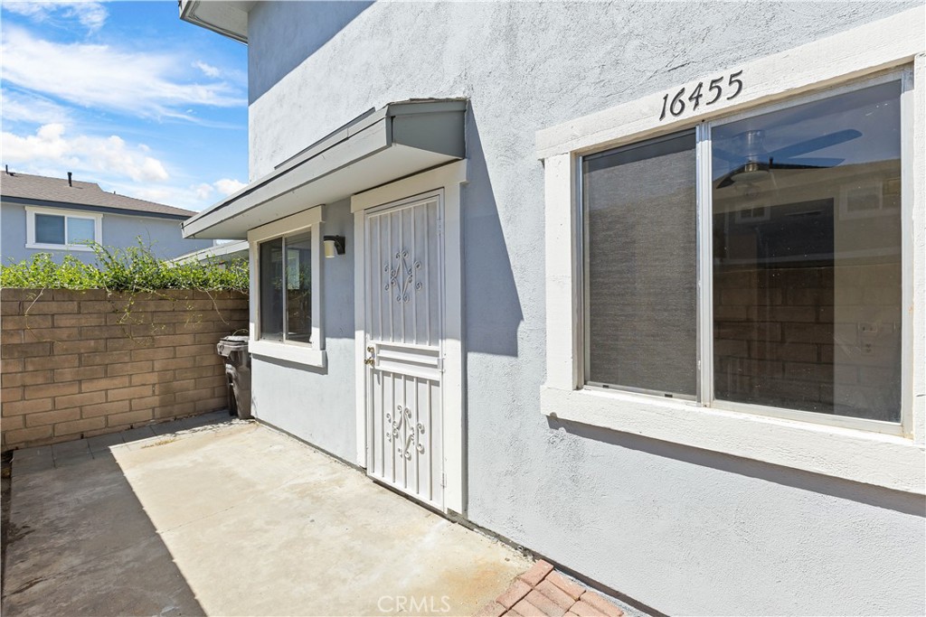 This charming and updated end-unit condo located in the desirable Huntington Harbor Heights Villas community. This two-bedroom, one-bath home features a convenient ground-floor entrance and a private patio, perfect for enjoying the coastal breeze. Inside, the open-concept layout creates a spacious and inviting atmosphere, seamlessly connecting the living room, dining area, and kitchen. Upstairs, you'll find both bedrooms, including a primary suite with a walk-in closet. The home has been freshly painted and thoughtfully updated with new laminate vinyl plank flooring throughout the downstairs and bathroom, as well as new carpet on the stairs, hallway, and bedrooms.
The unit has easy access to the garage and enjoys the privacy and quiet of an end location. Residents of Huntington Harbor Heights Villas enjoy a range of community amenities, including a pool, sports court, clubhouse, and beautifully maintained park-like grounds shaded by mature trees. Ideally situated near the harbor, beaches, shopping, and dining, this home has the best of coastal living in a serene, well-kept neighborhood.