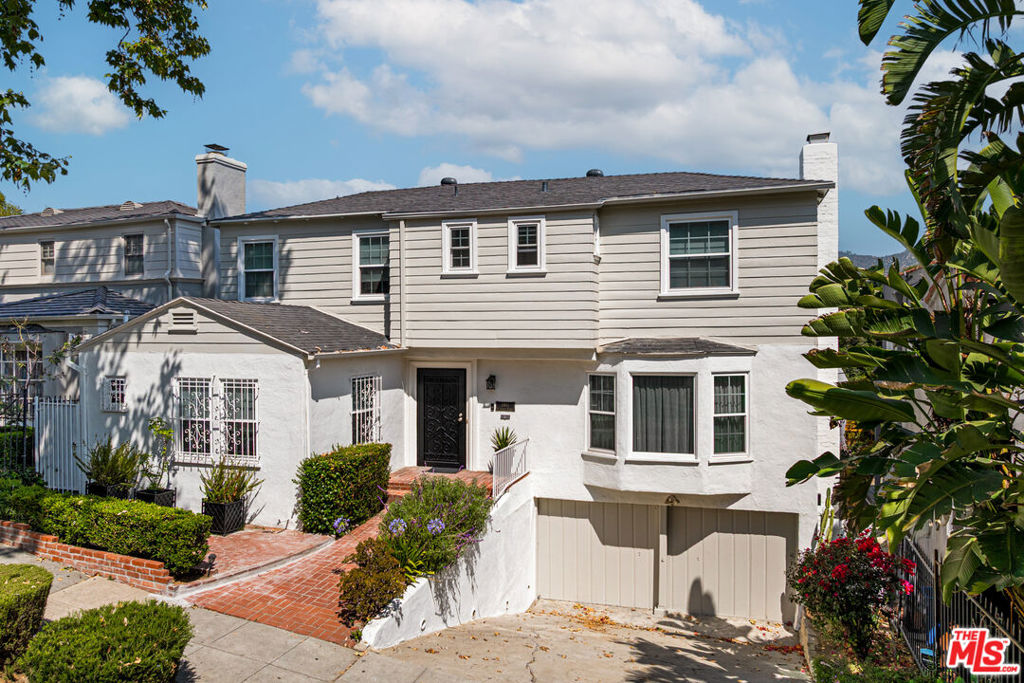 Nestled in the heart of historic Franklin Hills, this charming 1935 residence masterfully blends timeless character with modern upgrades. Offering 3 bedrooms and a versatile den across 1,854 square feet of thoughtfully designed living space, the home sits on a generous 7,000 square foot lot with panoramic city views and iconic sightlines to the Griffith Park Observatory. Beyond its classic facade, the home has been meticulously updated for contemporary living. Recent enhancements include new electrical wiring and panel, energy-efficient LED lighting throughout, brand-new HVAC system, and double-pane windows for year-round comfort. A fresh coat of interior and exterior paint provides a crisp, clean aesthetic that highlights the home's original architectural details most notably, the beautifully preserved hardwood floors and a striking wood-burning fireplace that anchors the living room with warmth and authenticity. French doors open to a sun-drenched balcony, where breathtaking views of the Los Angeles skyline and Griffith Park Observatory create an inspiring backdrop for morning coffee or evening repose. The updated kitchen is outfitted with sleek new appliances, marrying functionality with understated style. Outdoors, the expansive backyard invites both tranquil relaxation and vibrant entertaining. The lush, private setting includes a powered storage shed and ample space for alfresco dining or weekend gatherings under the stars. A rare attached 2-car garage adds convenience and practicality to this storybook setting. With its fusion of original charm and thoughtful updates, this Franklin Hills gem is a rare offering an elegant retreat that celebrates the best of Los Angeles living.