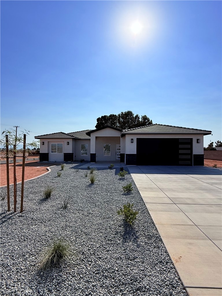 New Construction Home in Apple valley! This home features an open floor plan with 3 spacious bedrooms and 2 baths with an open living space. The living room includes a stunning tile wall with an electric fireplace. The gourmet kitchen is equipped with top-of-the-line stainless steel appliances, ample cabinets, a walk-in pantry, plus an oversized island, ideal for entertaining and family gatherings. The Master bedroom is generously-sized and master bath includes double sinks, a large walk-in shower, and a walk-in closet that provides all the storage you need for your wardrobe and accessories. Also, the indoor laundry room comes with lots of storage. This home offers an oversized twocar garage and patio cover in the back yard for all those summer BBQ's. SOLAR IS PAID OFF! This lot awaits your personal touch, offering landscaping possibilities and ample space to create your own oasis. You will absolutely fall in Love with this home!*Photos are not of subject property but similar model previously sold. Colors, fixtures & landscaping will vary*