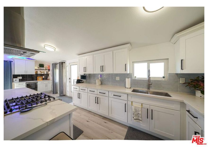 Beautiful single-family residence located in the heart of Anaheim, West Harbor! Only a 5-minute drive to Disneyland! As you enter the one-story home in the quiet and desirable neighborhood, you will be greeted with an open floor layout with a fully remodeled kitchen, gorgeous stone countertops throughout, with elevated white cabinets, the kitchen includes a stove, oven, microwave, and refrigerator all stainless steel appliances to prepare multiple dishes; the premises also features double pane windows and sliding doors allowing natural light to come in. It's a true benefit having waterproof vinyl flooring throughout the entire house with energy-efficient LED recessed lighting, with a charmed custom-made bar area; grab a bottle from the wine cellar and enjoy a glass of vino for those relaxing evenings. The dining area is lovely and warm for any gathering, watch your preferred TV series in the open living room, or just unwind. As you walk into the hallway, the indoor laundry closet comes with W/D and storage space to make your life easier. The house features 2 bedrooms and one full bathroom. Please note the main bedroom has a spacious walk-in closet to accommodate your belongings. This house offers a range of amenities that will surely meet your needs. New climate-control systems, electrical upgrades, and solar panels are installed to be cost-effective. The front fenced and the backyard provide a safe and private space for outdoor activities, like delighting on a hot day in the pool, grilling delicious meals to entertain your family and friends, and in the evenings being blessed with the amazing Disneyland fireworks in the comfort of the covered deck patio, making it convenient and unique! The concrete driveway perfectly accommodates 2 vehicles, plus you can store 2 more vehicles inside the detached garage; additionally, the storage shed offers ample space to keep your home organized and clutter-free. The entire house is ideal for those seeking a cozy and functional living space to call their new HOME. The tenant pays for all utility bills, and the Landlord covers the pool and gardening services to keep the home nice and neat. The residence is centrally located at a corner lot, and it's move-in ready! close to many shops, restaurants, excellent schools, and much more. Available December 1st, 2025.