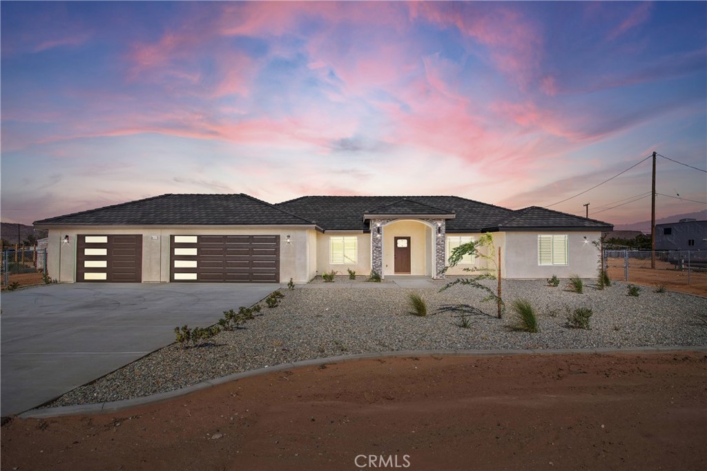 Gorgeous New Construction on Fully Fenced Acre • Apple Valley Retreat •
Welcome to this stunning all-electric home—complete with paid-off solar panels to keep your energy costs low. Built with worry-free living in mind, it features an installed automatic fire sprinkler system for added peace of mind. This move-in-ready gem sits on a fully fenced one-acre lot in picturesque Apple Valley.
Step inside to find 2,354 sq ft of thoughtfully designed space, including 4 roomy bedrooms, 2 primary suites—each with its own walk-in closet—and 3 beautifully appointed bathrooms. The standout primary bathroom truly shines as a retreat, offering a spa-like atmosphere designed for relaxation, serenity and self-care, complete with upscale finishes and calming ambiance.
The heart of the home is the oversized chef-inspired kitchen—ideal for entertaining or everyday family living. It features premium finishes, a large island with a breakfast bar, and a seamless flow into the open great room that’s designed with family movie nights, game time, and gathering in mind.
Throughout the house, brightness and charm abound: warm-tone laminate flooring, striking black fixtures, and custom wooden shutters—every detail thoughtfully curated for both style and function.
Outside, the low-maintenance front yard features concrete curbing filled with decorative rock and drought-tolerant plants, offering clean curb appeal that suits the desert setting. The 3-car finished garage, complete with modern doors, gives you ample space for vehicles, hobbies, or storage needs.
This is more than just a home—it’s your backdrop for everyday memories, celebrations, and relaxed high-desert living. Priced to sell and ready for its next chapter— Pack your bags it's time to move!!