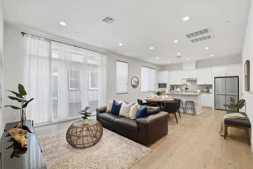 Contemporary elegance defines this immaculate 2-bedroom, 2.5-bath, 1,301 SF award-winning townhome built in 2019, magnificently designed with refined modernity. Ascend to the expansive main living area with soaring ceilings, gleaming oak floors, recessed lighting, and oversized windows that fill the home with natural light. The chef's kitchen showcases high-end appliances, beautifully contrasted quartz countertops, custom white cabinetry, a walk-in pantry, stylish backsplash, and an oversized island flowing seamlessly into spacious dining and living areas, perfect for entertaining or everyday elevated living. Each bedroom is a private retreat with luxuriously appointed en-suite baths and custom-shelved closets. The primary suite is a light-filled sanctuary with soaring ceilings, a spacious walk-in closet, and a double vanity spa-like bath. Added conveniences include entry level powder room, attached 1-car garage, temp-controlled RO filtration, water softener, central heating & AC, Ring doorbell, in-unit washer/dryer, and an exceptional location near vibrant downtown, San Pedro Square, beloved restaurants, SAP Center, Pellier and Bassett Parks, major tech campuses, Caltrain and highways 880, 87, 101, and 280. Experience modern luxury in one of SJ's most desirable neighborhoods!